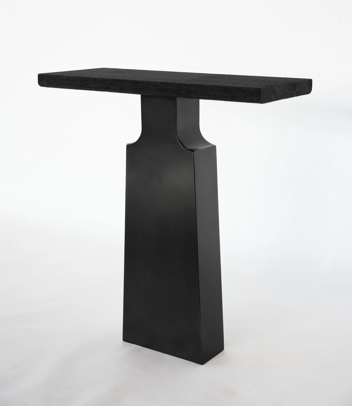 Minimalist black pedestal with a rectangular top against a white background.