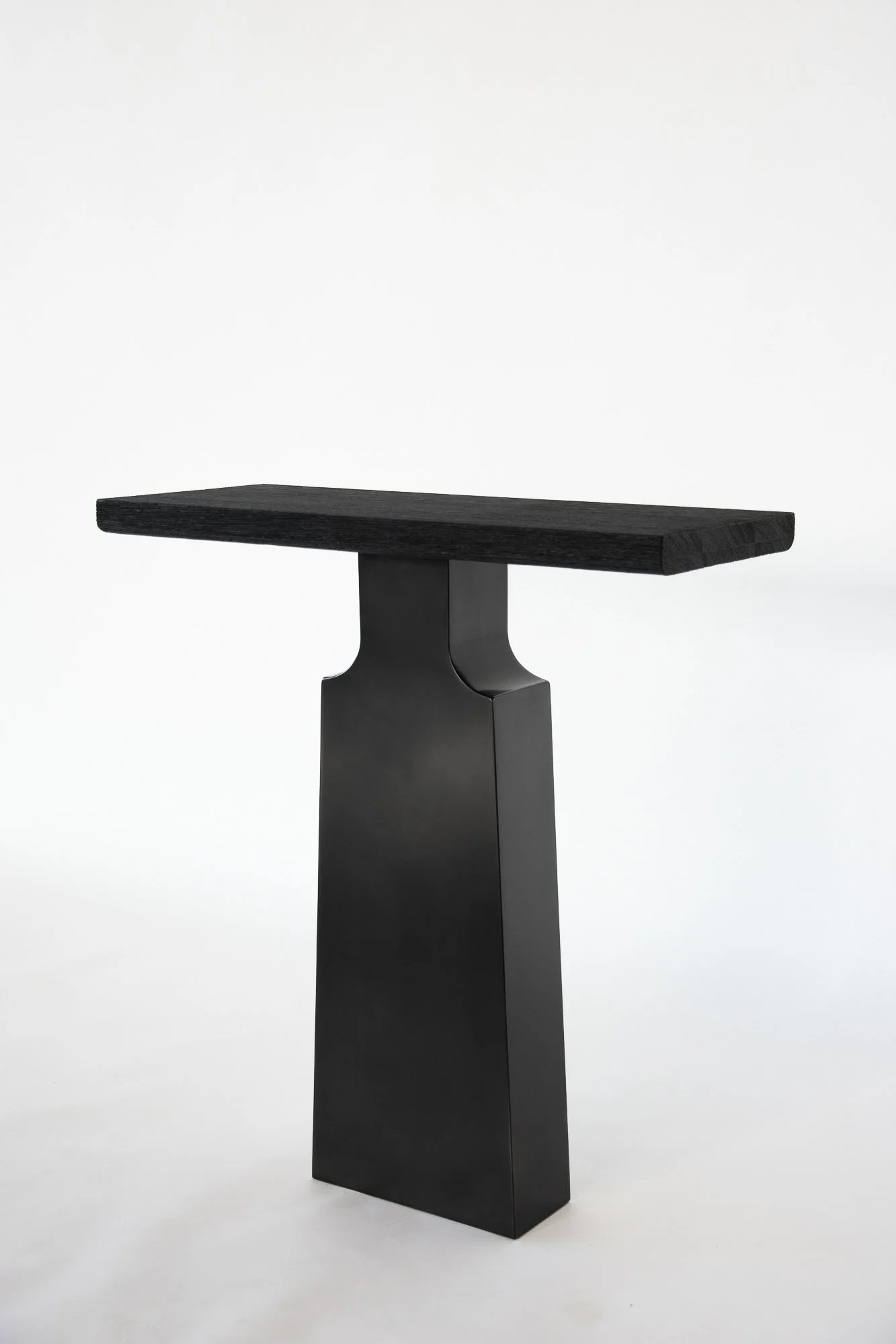 Black modern side table with a rectangular top and a geometric base, set against a plain white background.