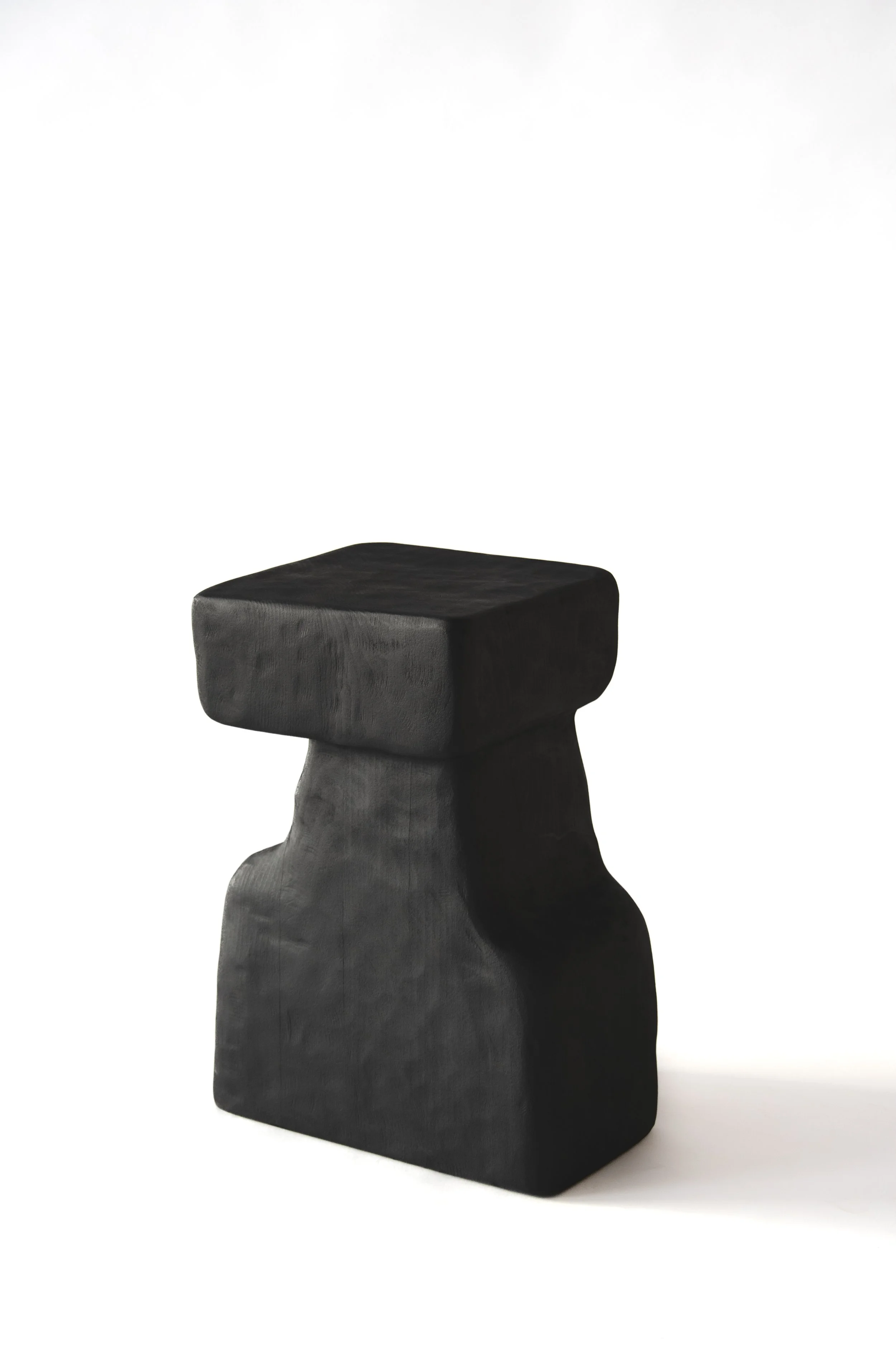 Black wooden stool with a square seat against a white background.