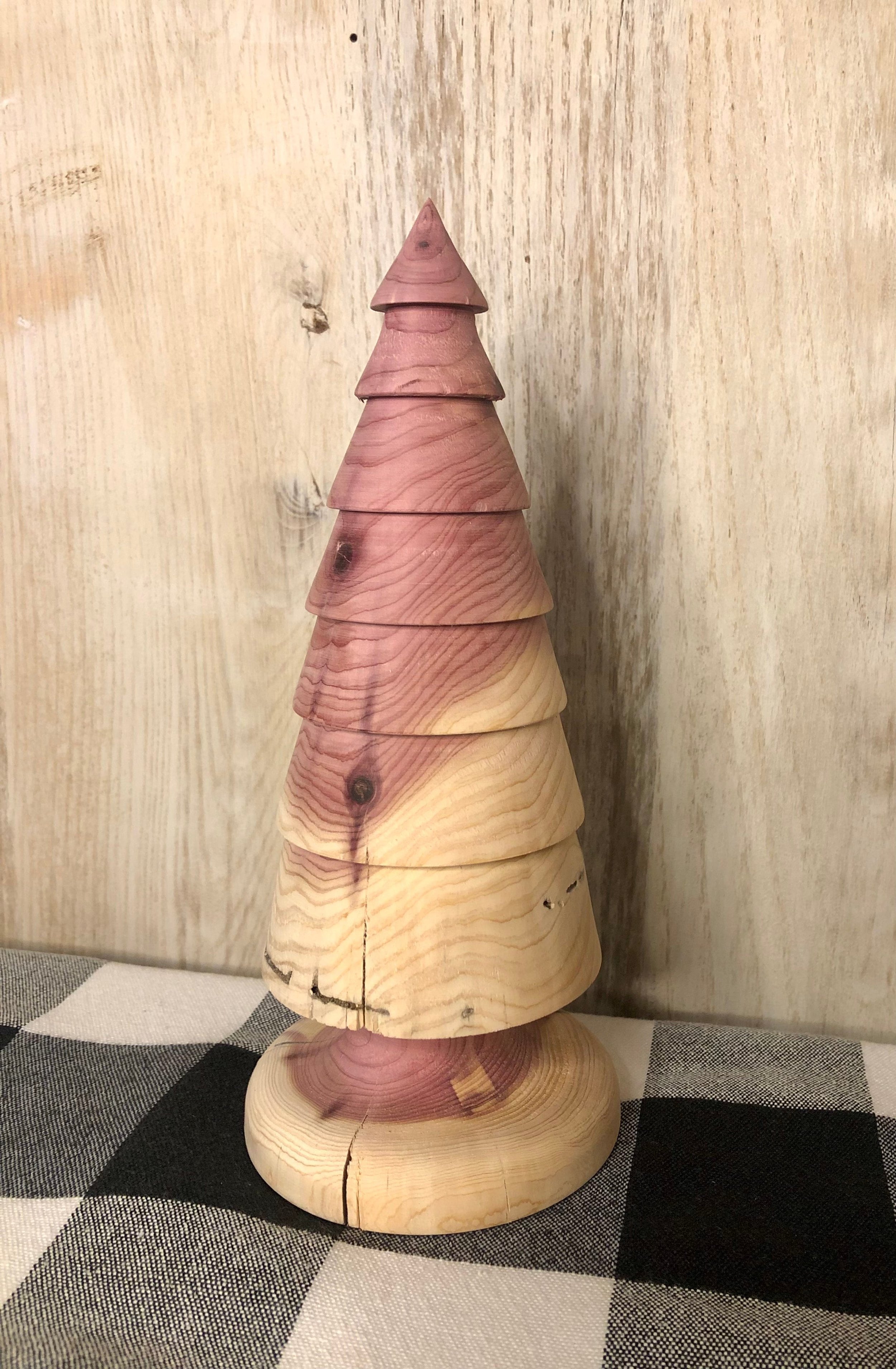 A single turned wood tree sitting on a table.