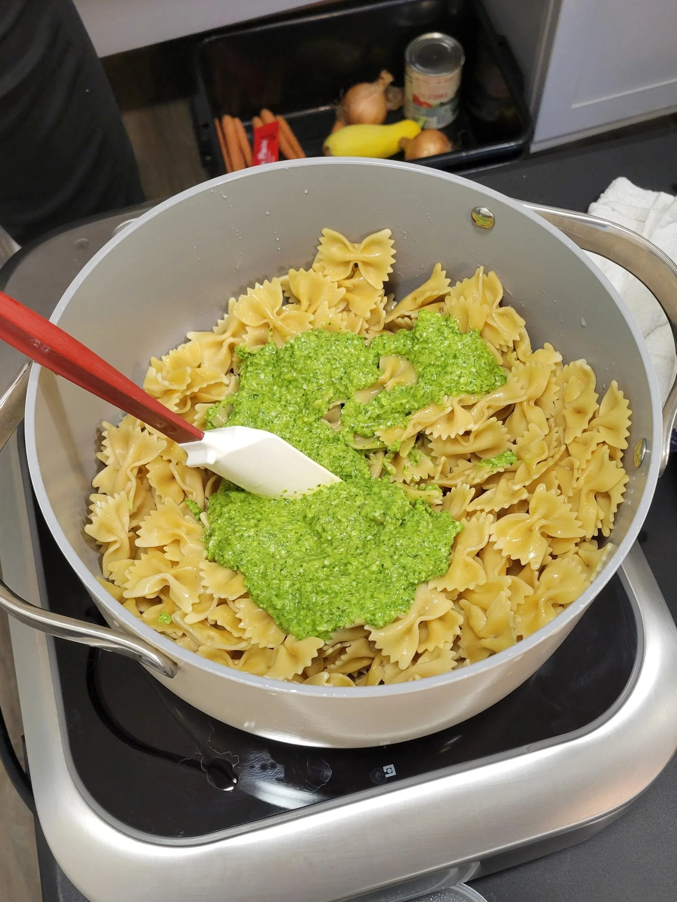 Bowtie pasta with broccoli pesto sauce ready to be mixed in.