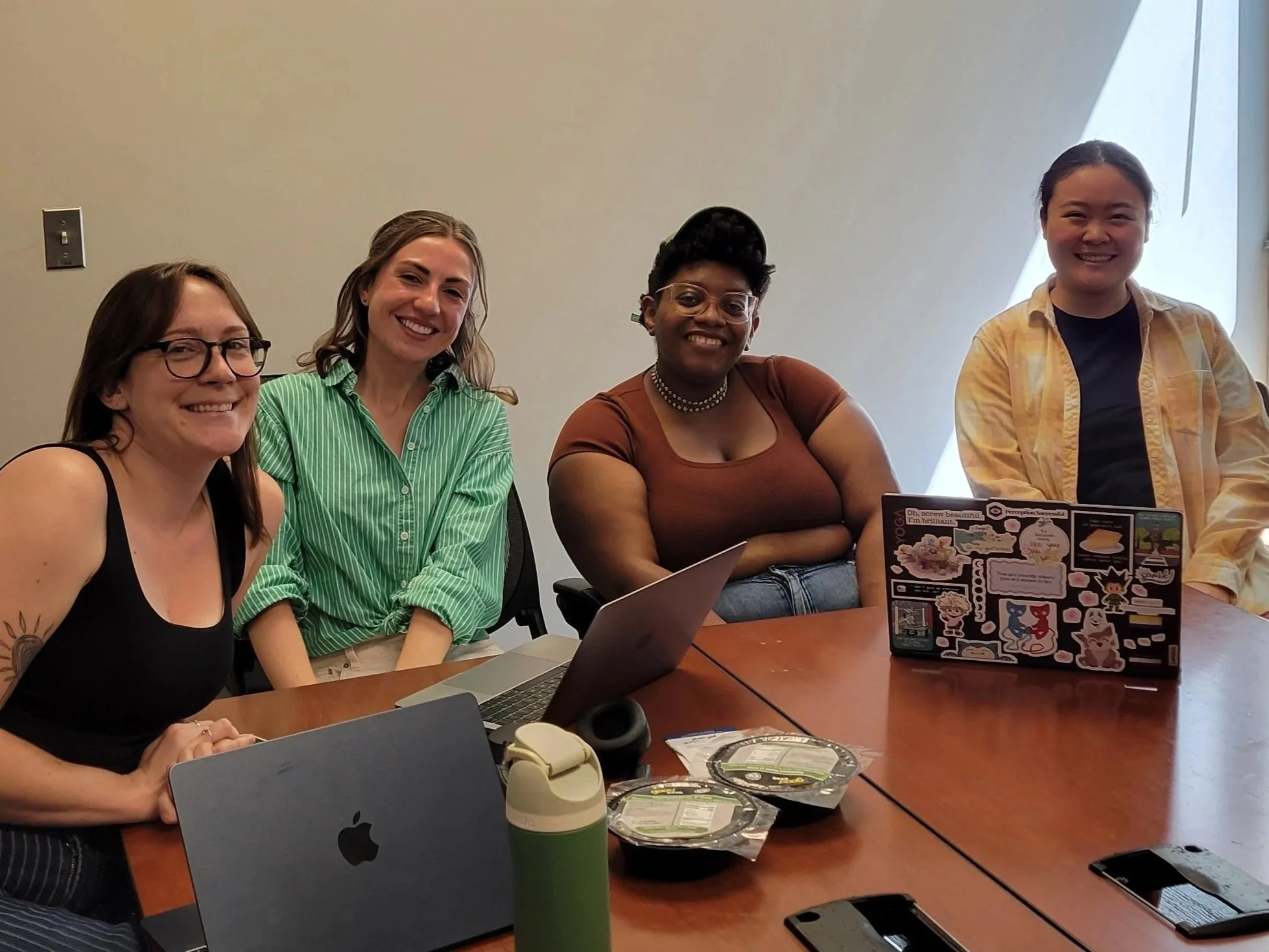 FEC's 2025-2026 Capstone Team, Thea, Meredith, Sabina, and Mei smiling together during a meeting.