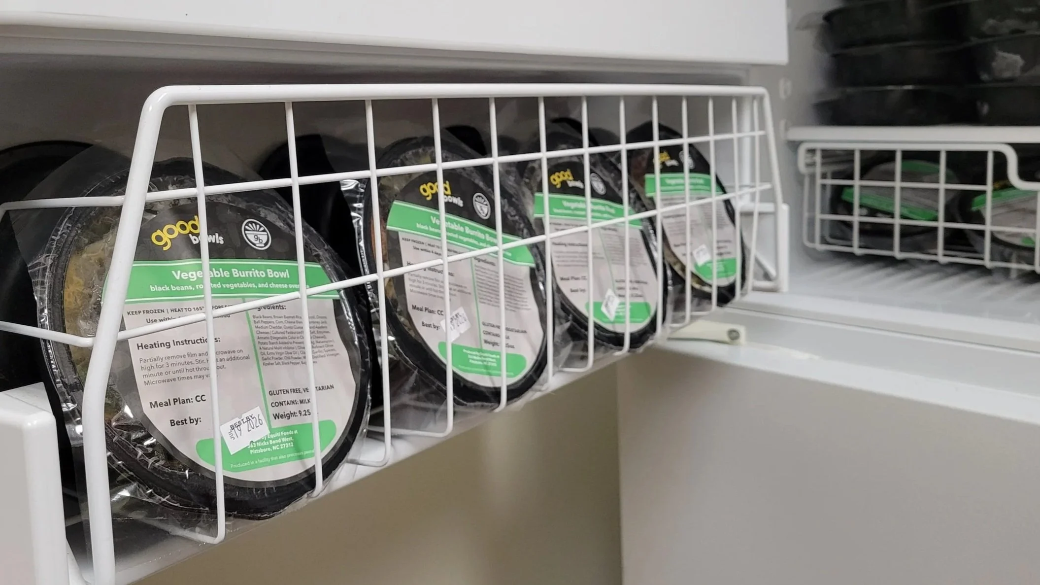 Good Bowls lining a freezer shelf.