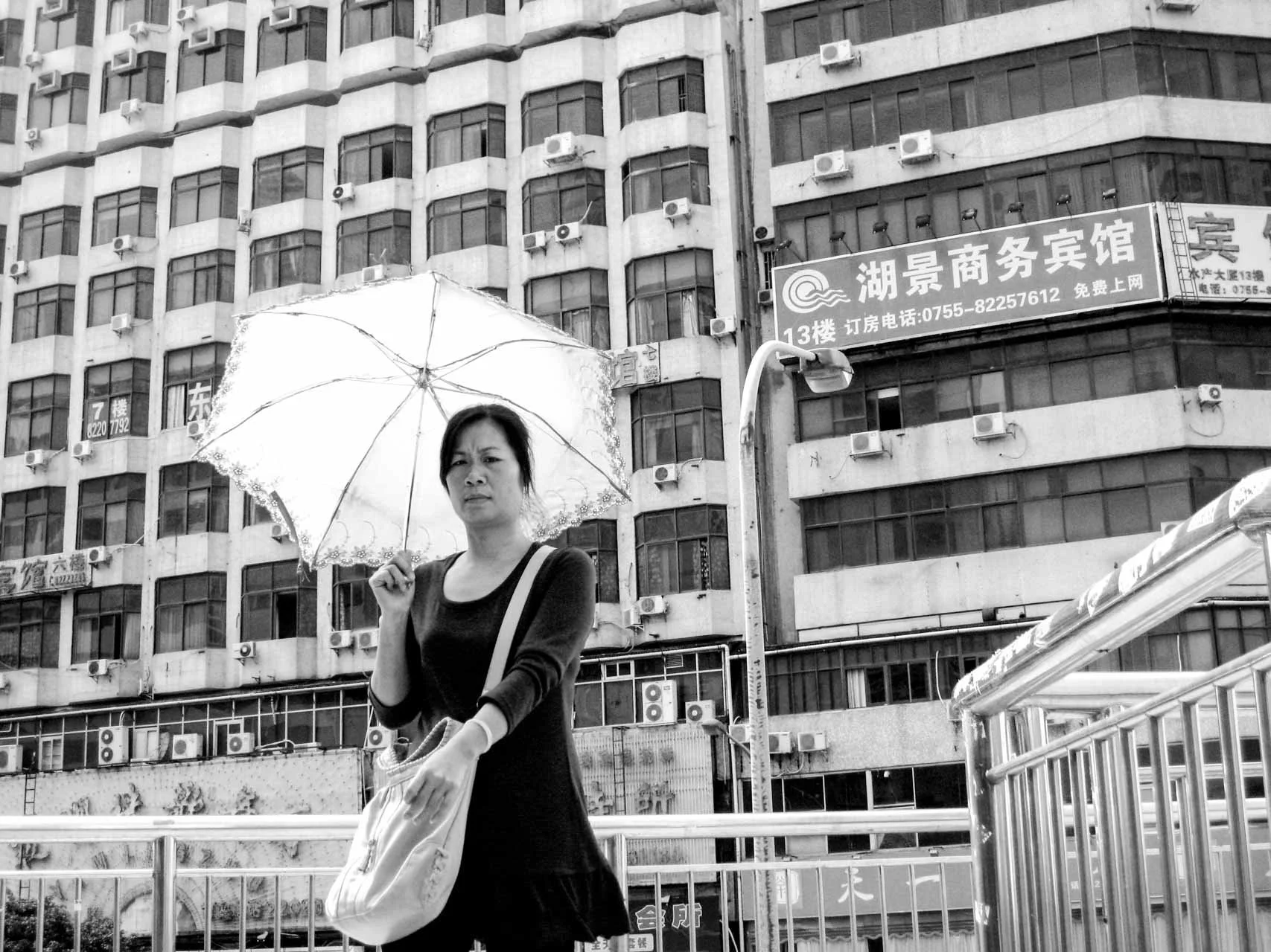 lady-with-parasol-on-footbridge-shenzhen-IMG_6117.jpg