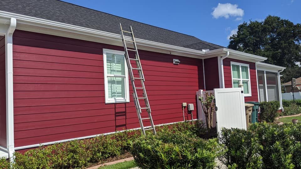Red house exterior with white trim after.