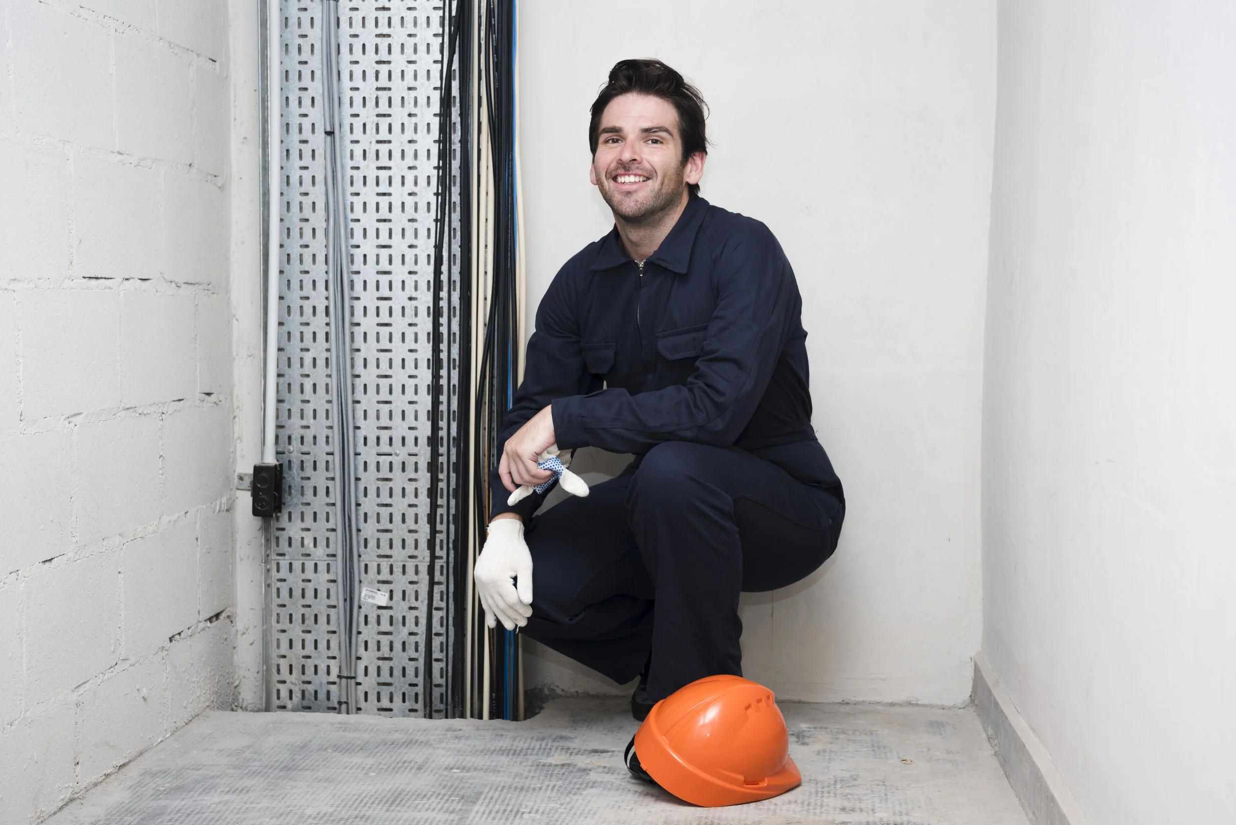 portrait-smiling-young-male-electrician-workplace.jpg
