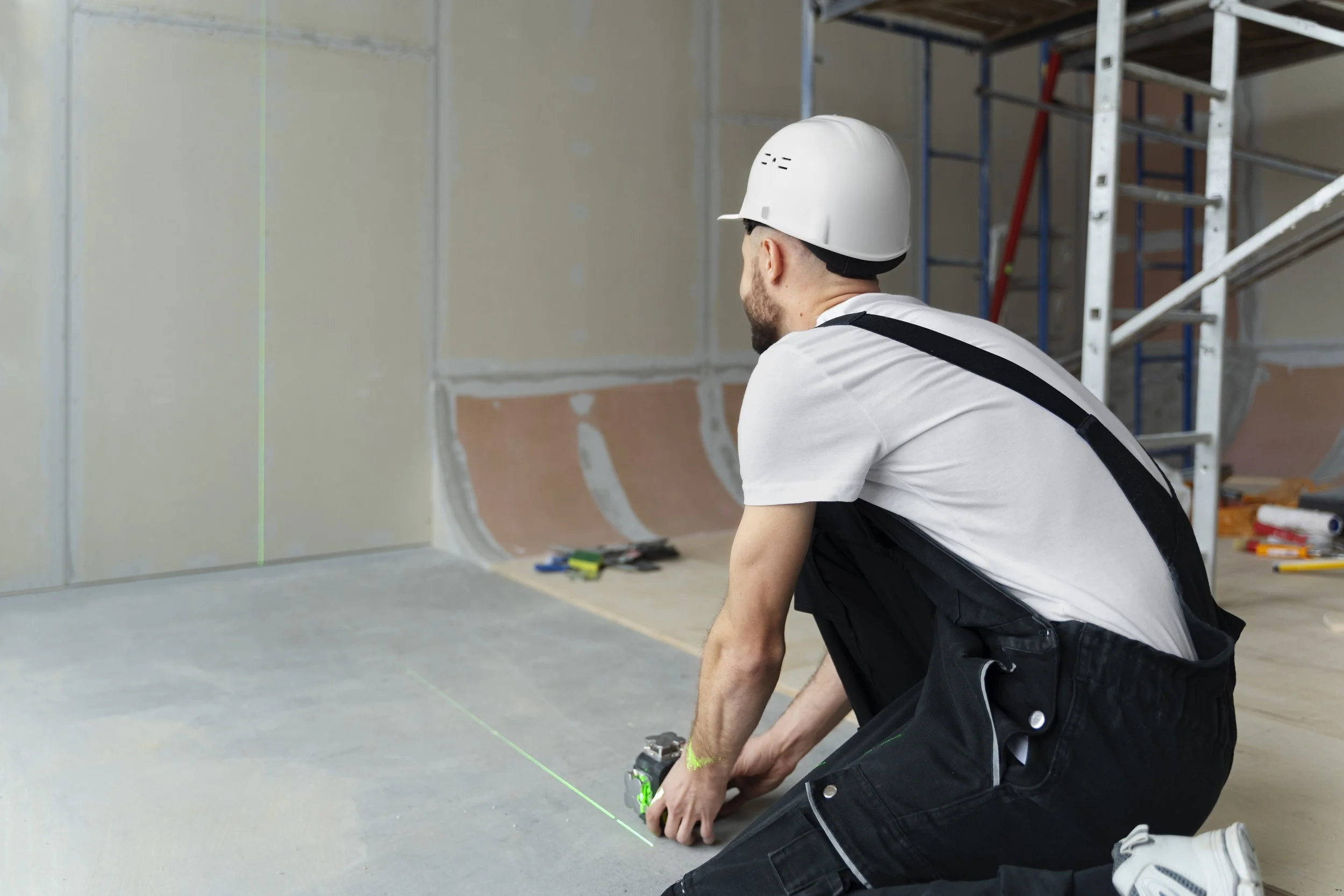 full-shot-construction-worker-holding-tool.jpg