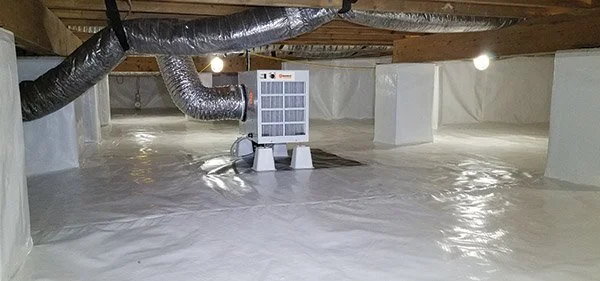 Unfinished attic space with HVAC ductwork and a portable air purifier on the floor.