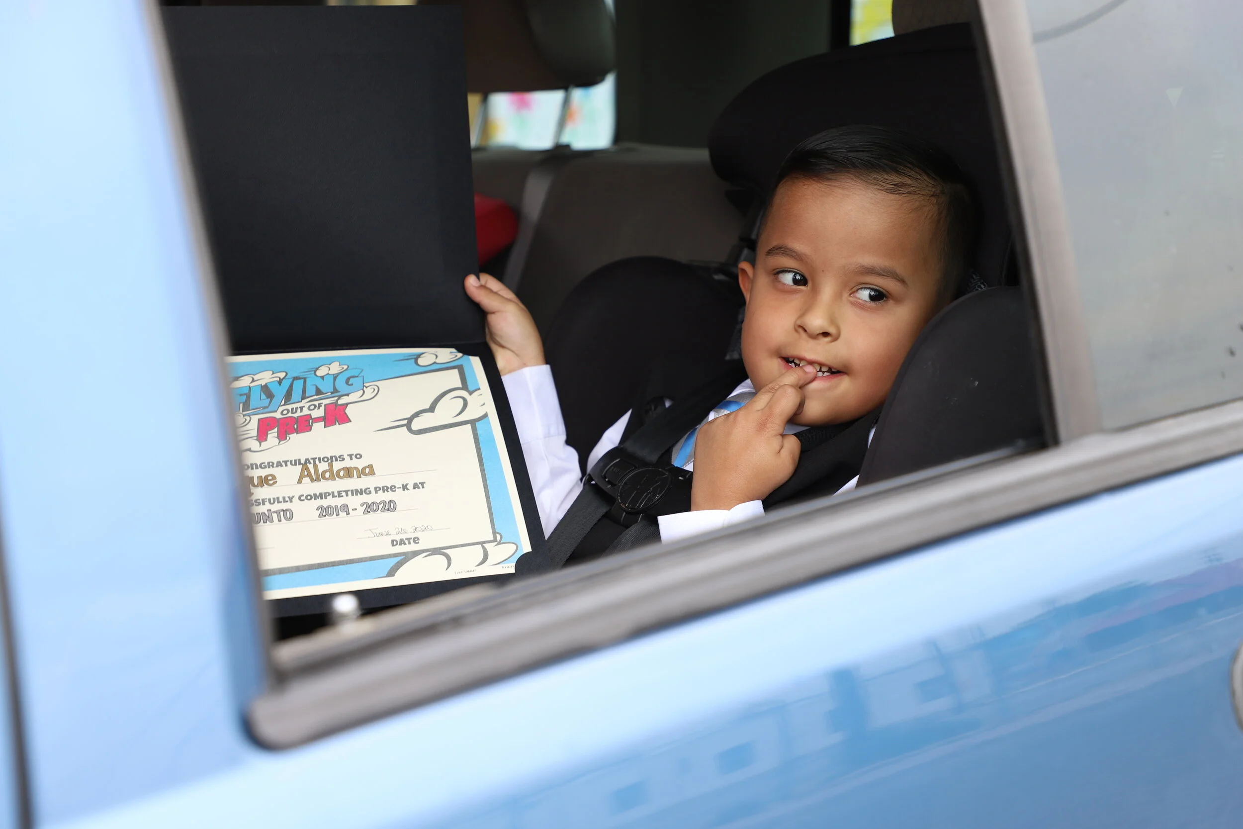  Enrique proudly showing his PreK diploma 