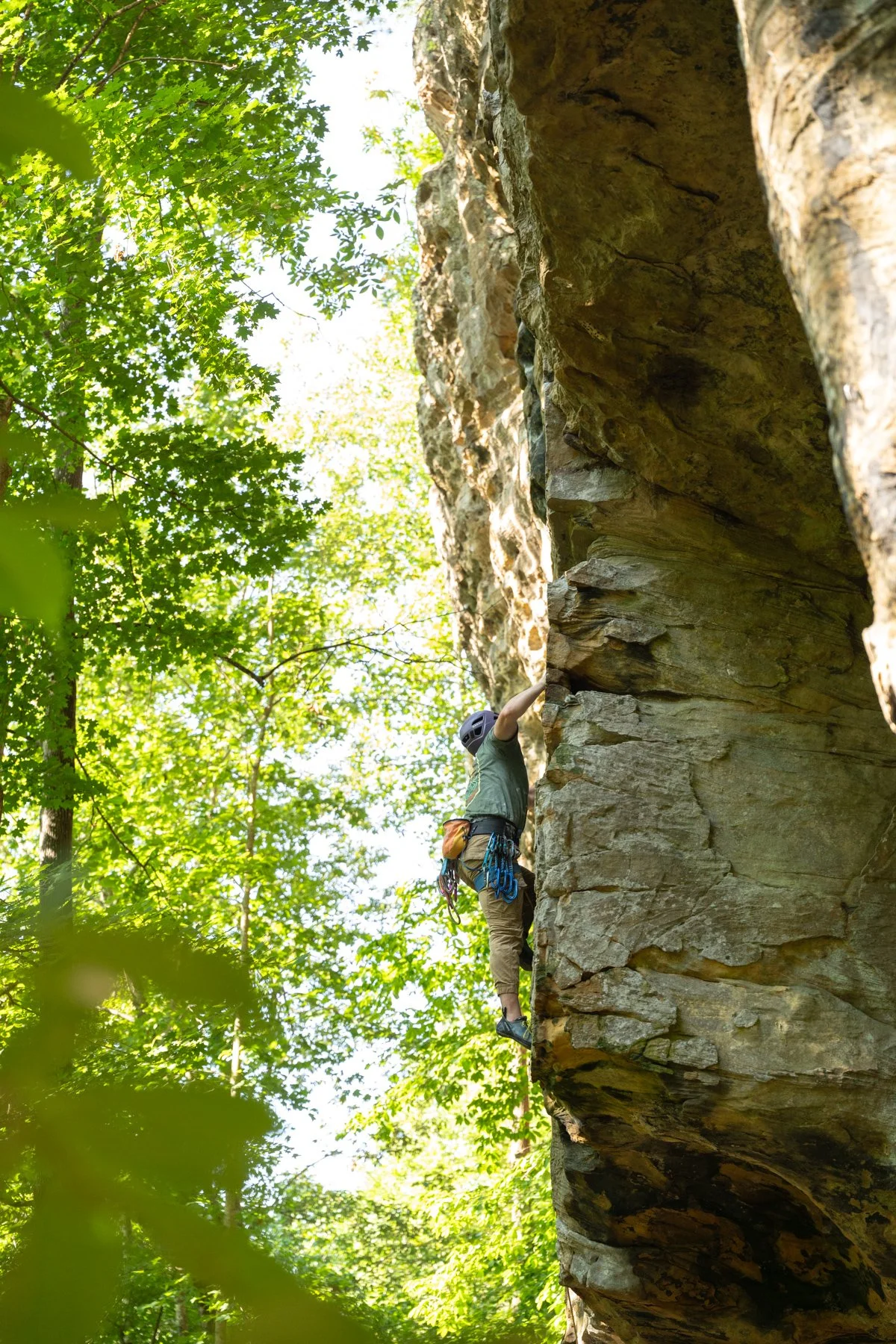 Man climbing up a sandstone arete at the Red River Gorge