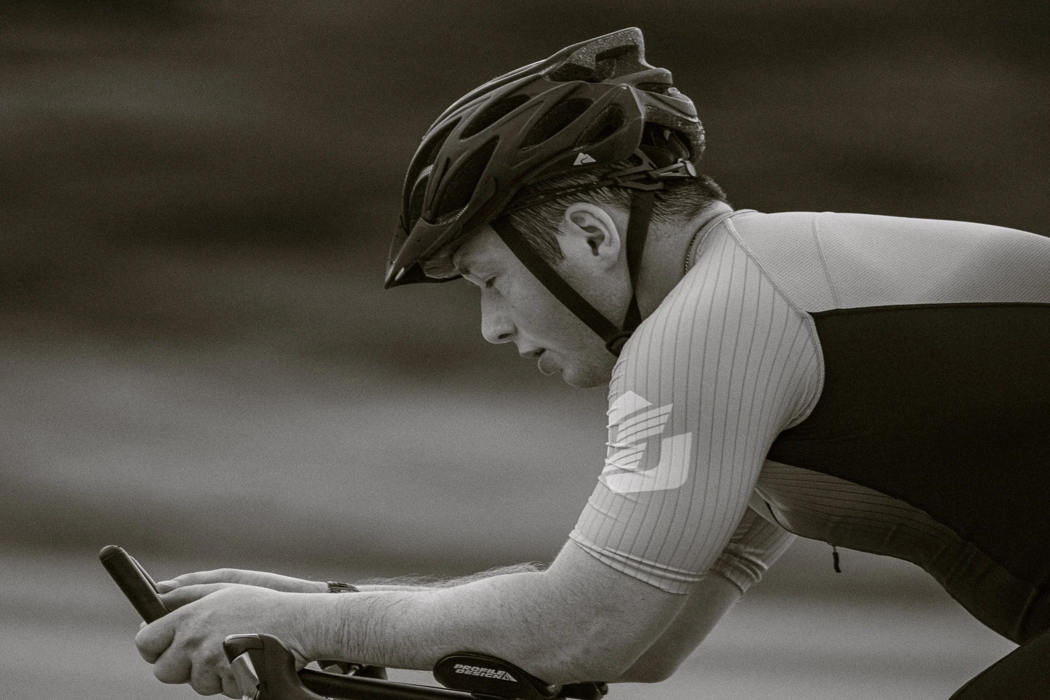 Black and white landscape shot of cyclist in a tri suit