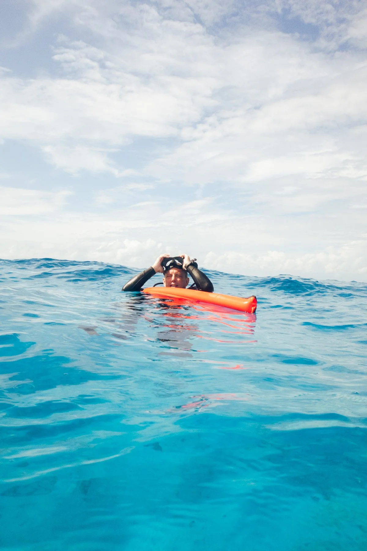 Diver surfaces with a safety sausage in Cozumel, Mexico