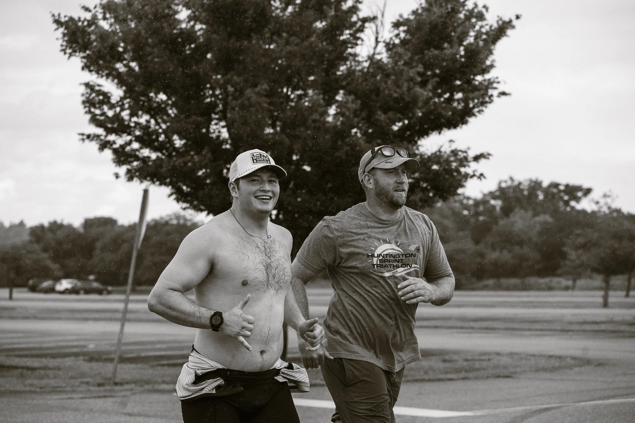 Black and white photo of two men on a run