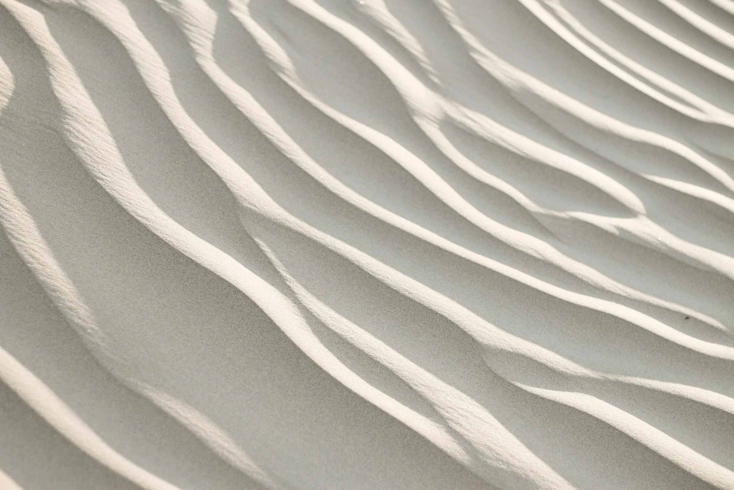 White sand patterns to symbolize the naturally shifting journey of finding wholistic success
