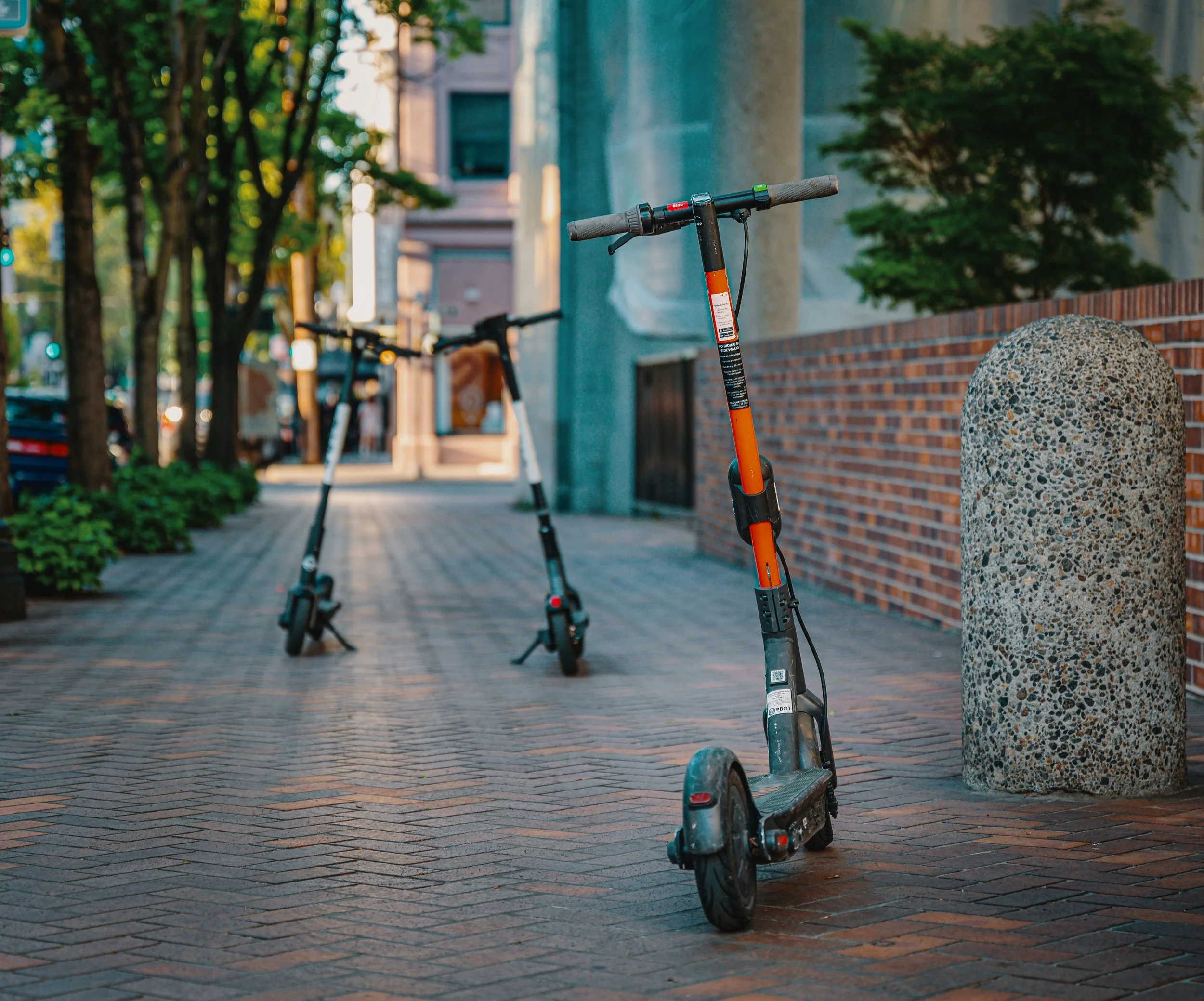 Electric scooters on a city sidewalk for the New Jersey e-scooter and e-bike accident lawyer page