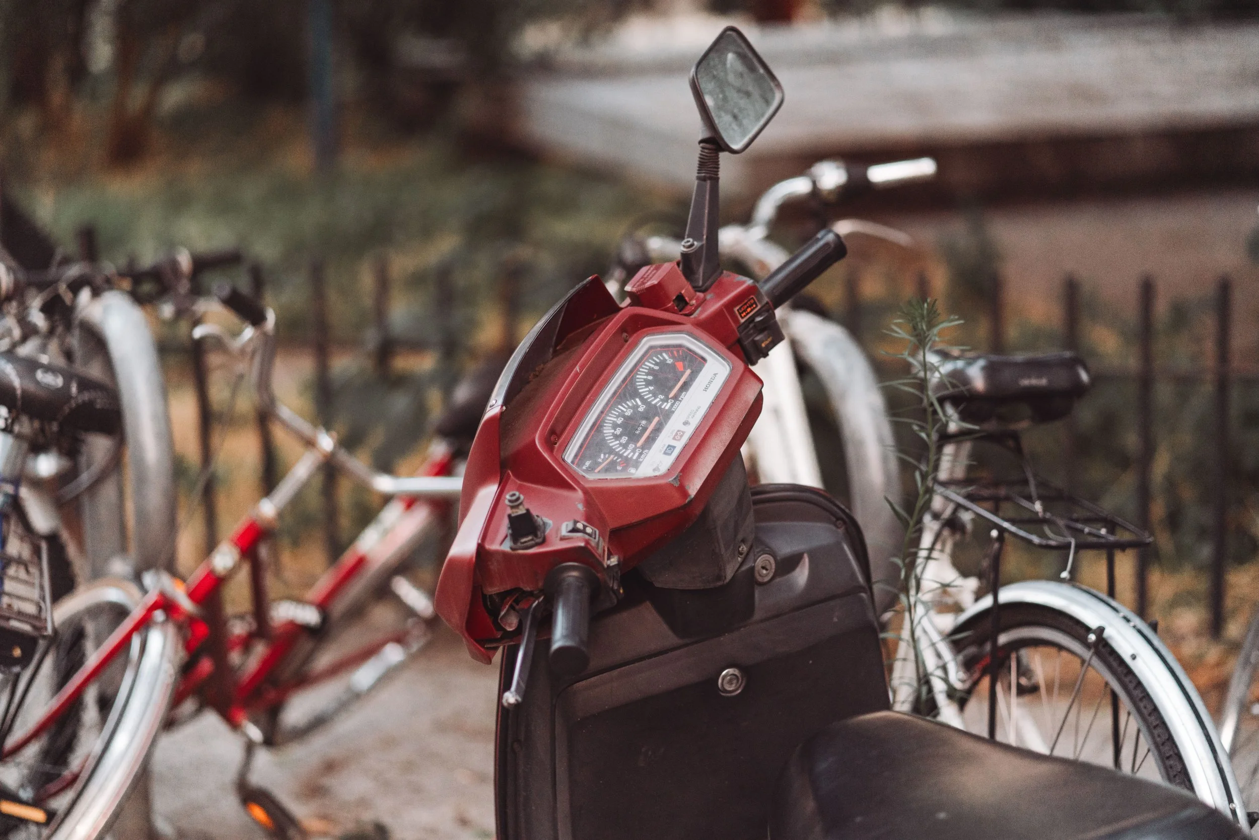 Red motorcycle parked beside bicycles, vulnerable road users in motorcycle and bicycle injury claims