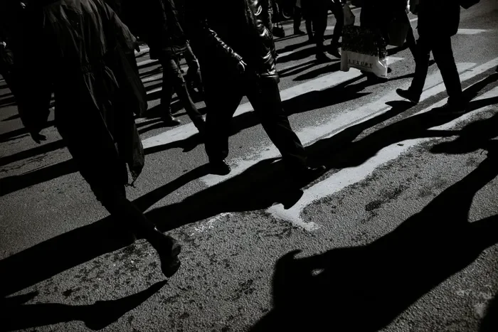 Pedestrians crossing a busy street in black and white, heavy traffic in North Bergen where collision evidence matters