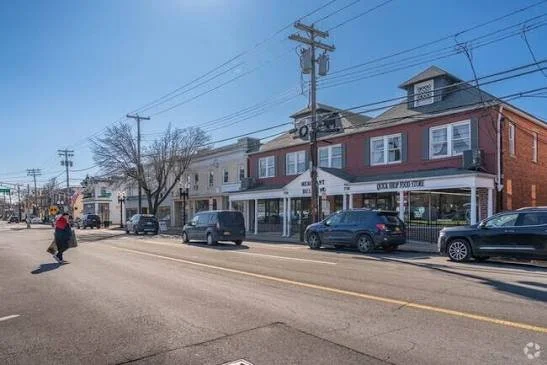 Street lined with small shops and parked cars in downtown Morris Plains, New Jersey