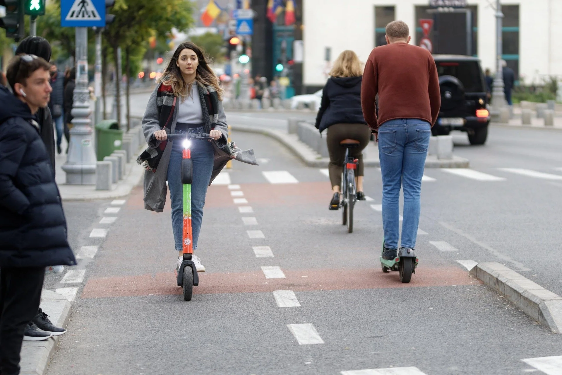 Electric scooter riders and a cyclist on an urban road illustrating evidence in New Jersey e-scooter and e-bike accident claims