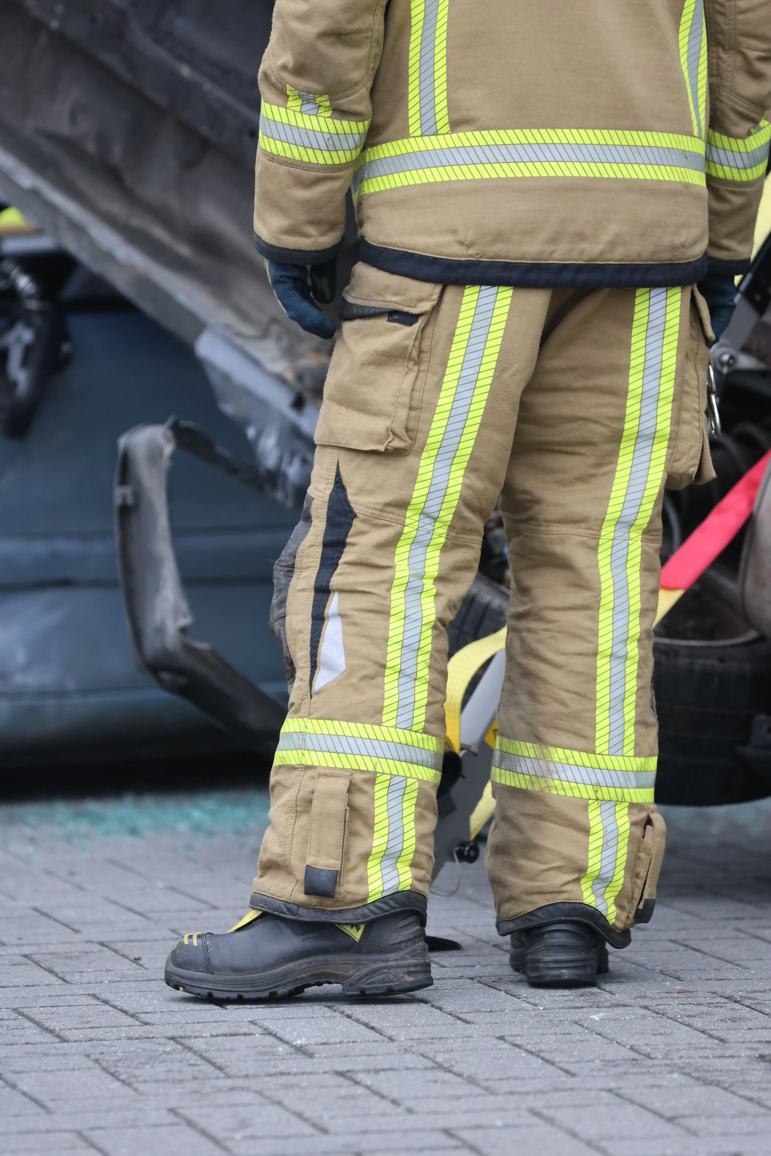 Firefighter in reflective gear at a serious accident scene where attention to the details matters