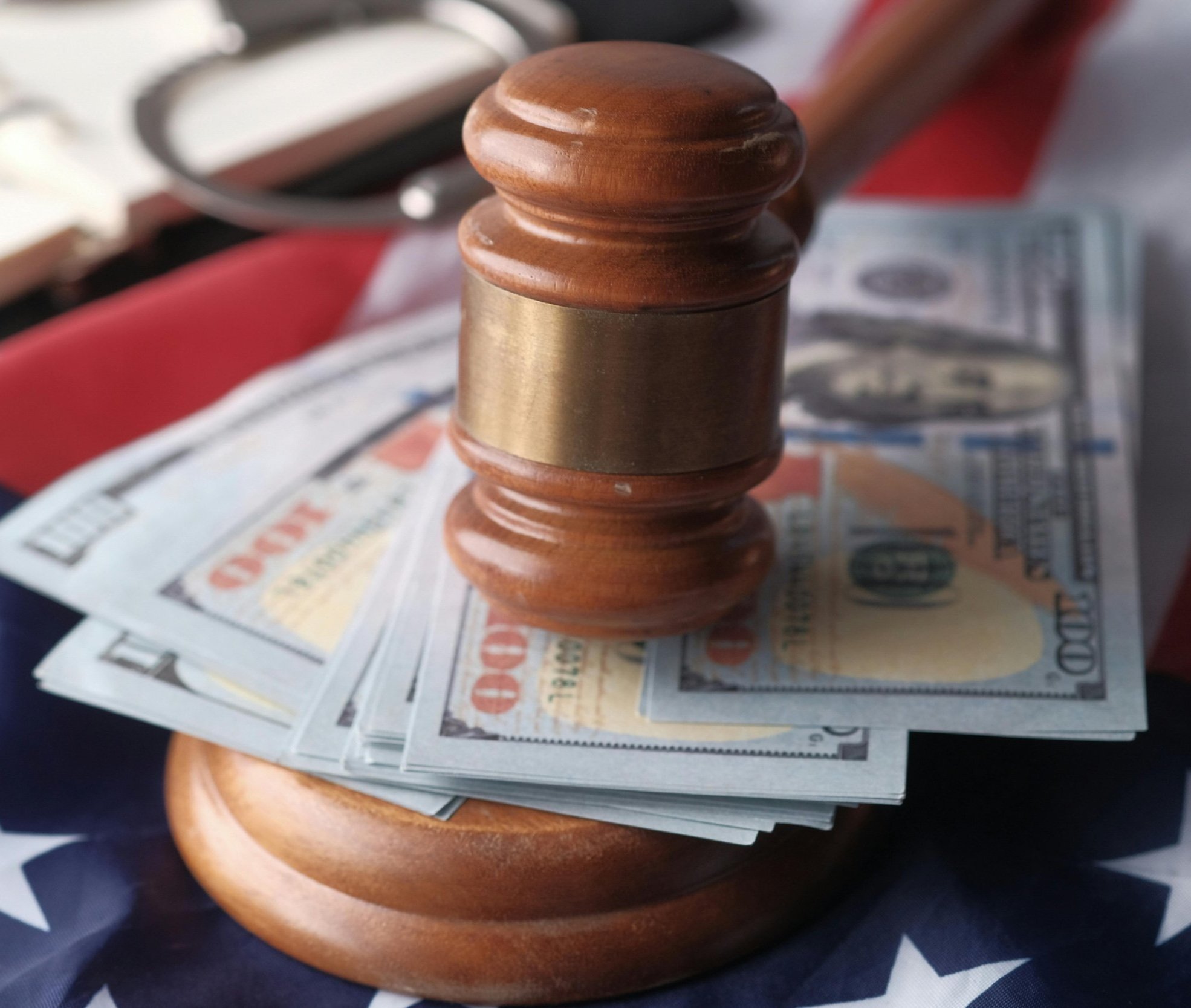 Gavel resting on US dollar bills symbolizing personal injury claim compensation