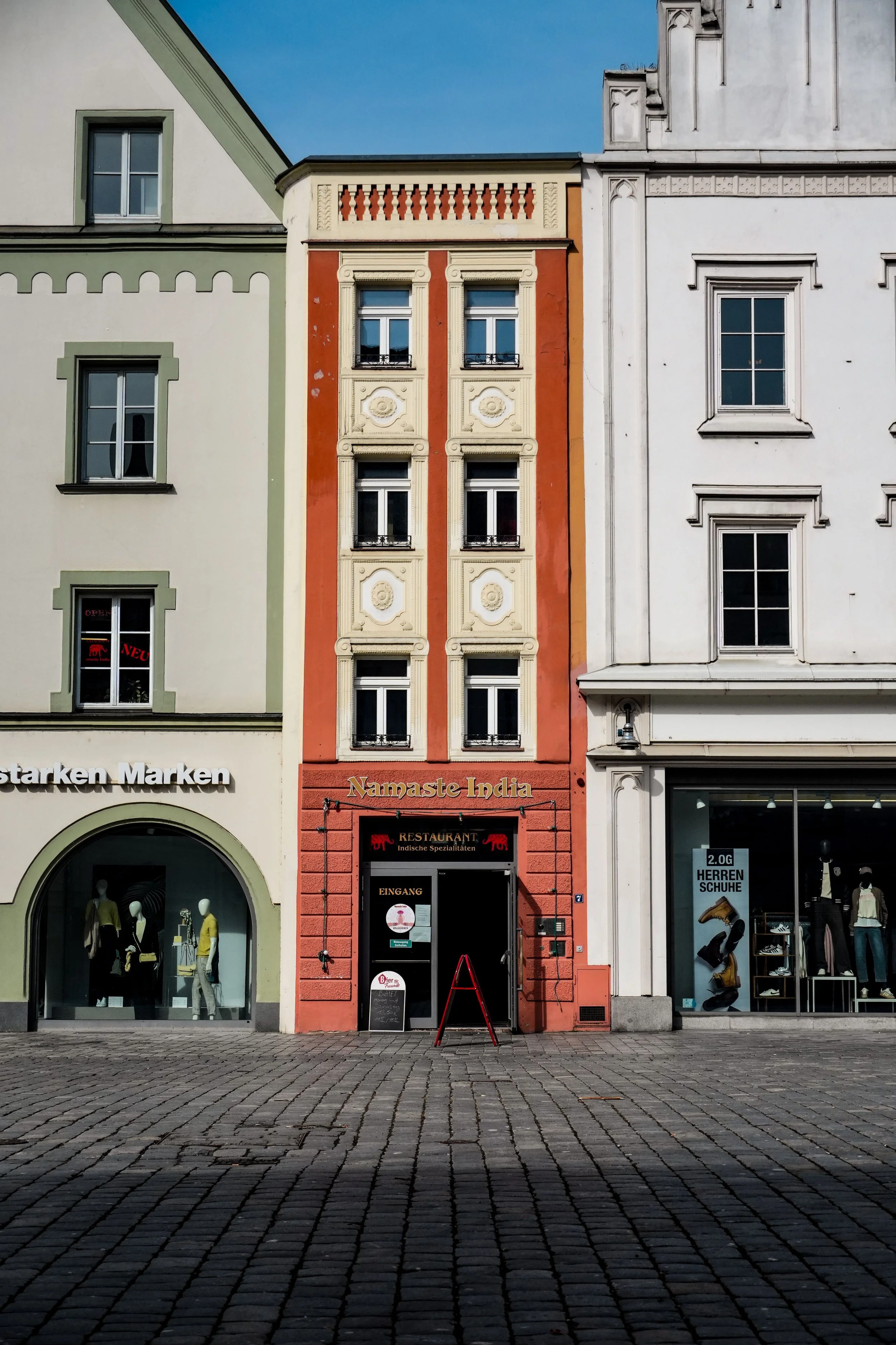 Retail shops and restaurant entrance on a cobblestone street, a commercial location for slip and fall accidents