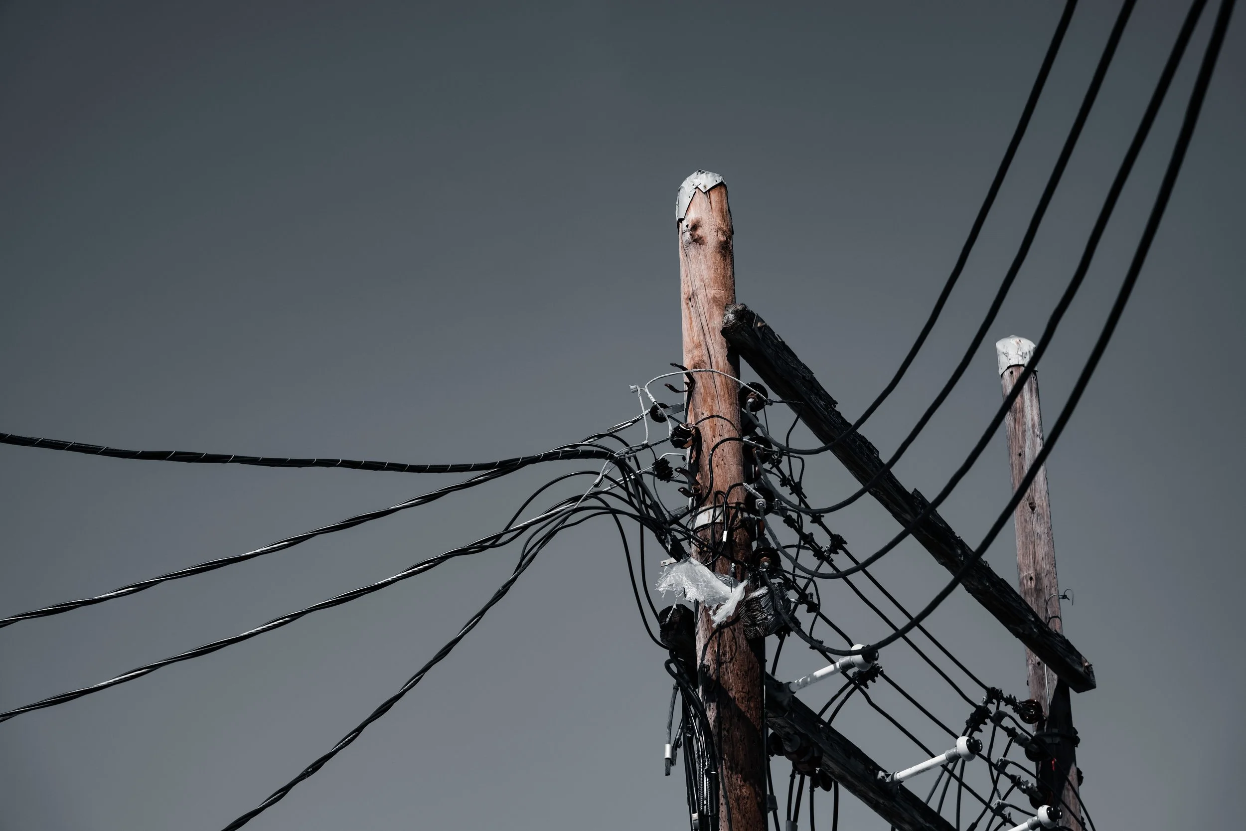 Tangled electrical wires on a utility pole, a faulty wiring and electrical defect hazard in product liability cases