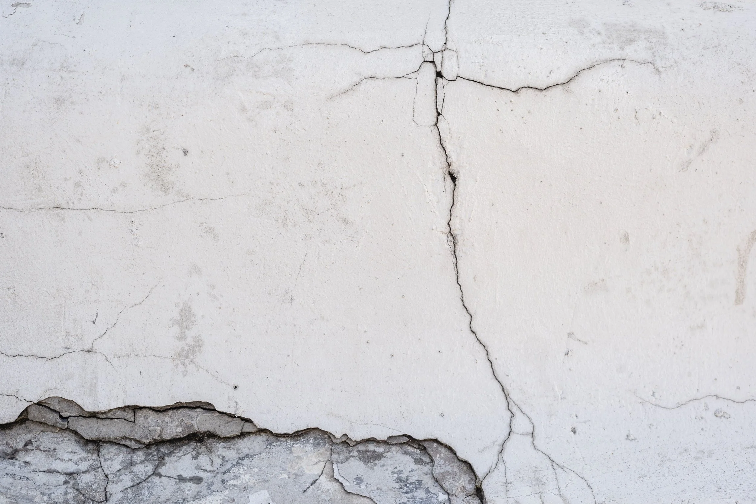 Cracked and crumbling concrete surface, representing cracked walkway hazards that cause trip and fall accidents