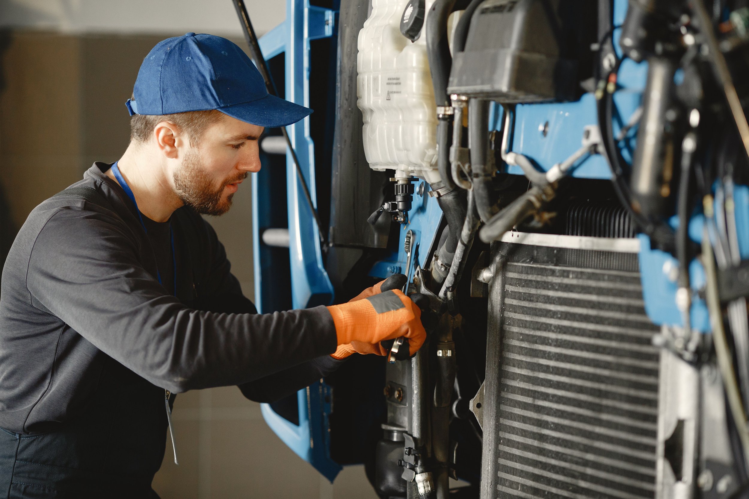 Mechanic inspecting vehicle equipment for defects, representing equipment problems in bicycle accident claims
