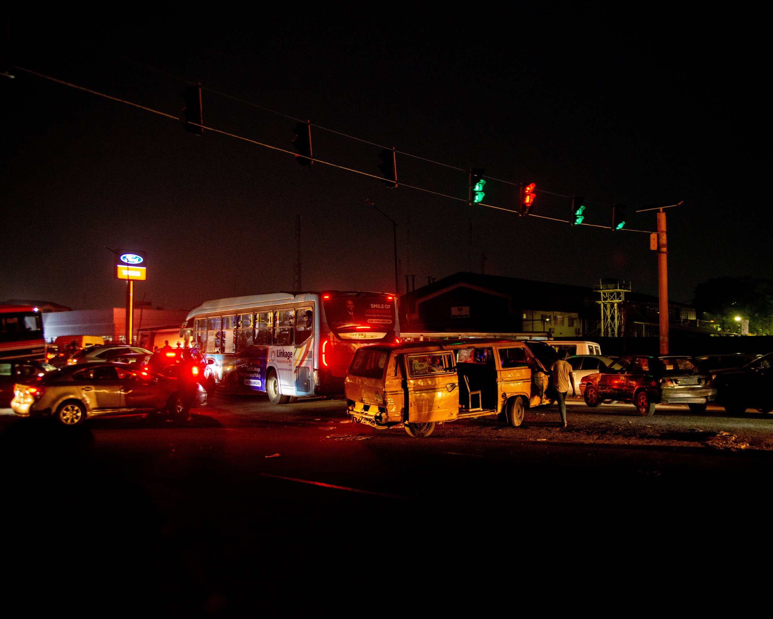 Night traffic with a bus and cars at a signal, a busy road where Jersey City car accidents can happen