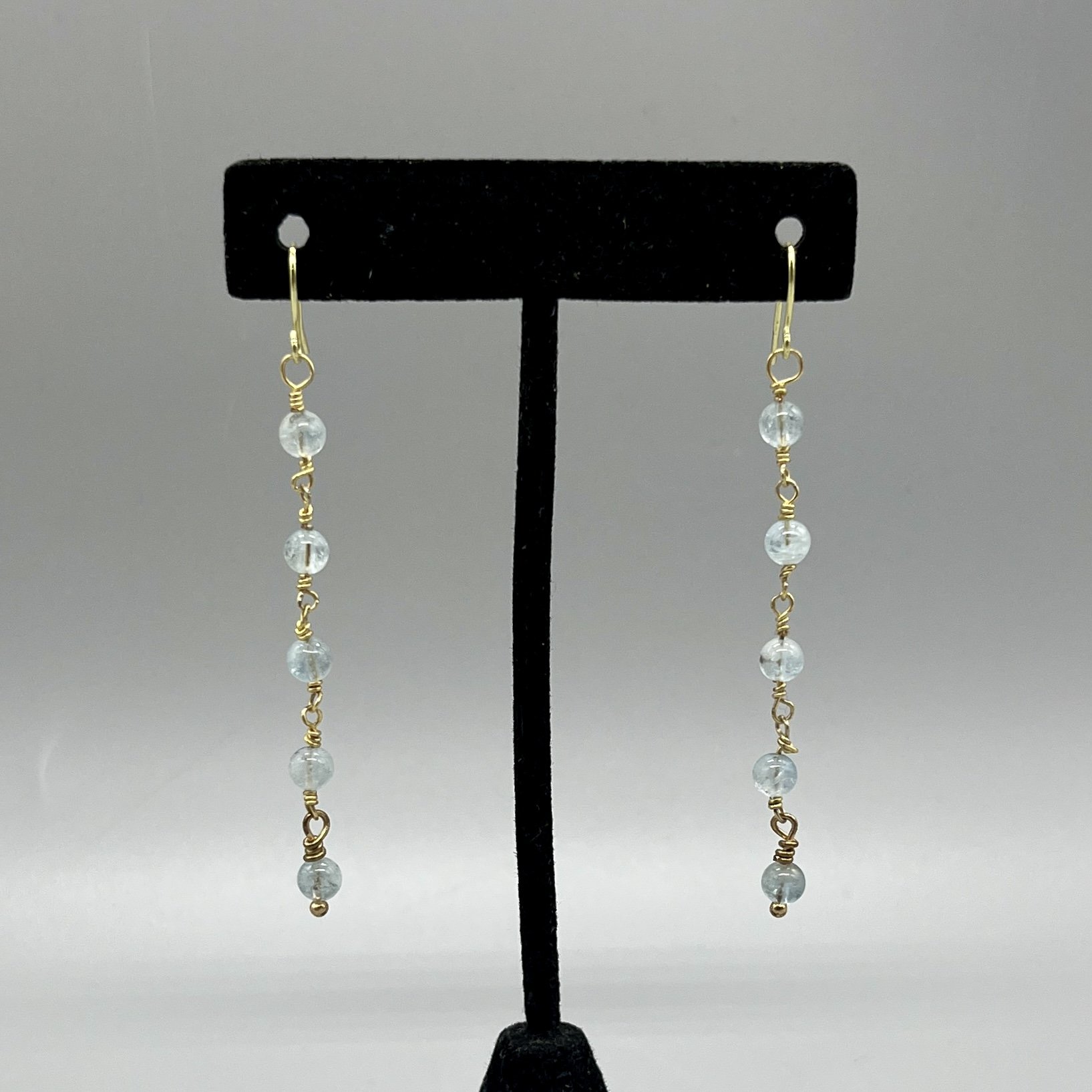 earrings light blue aquamarine 4mm beads chained together with gold colored wire