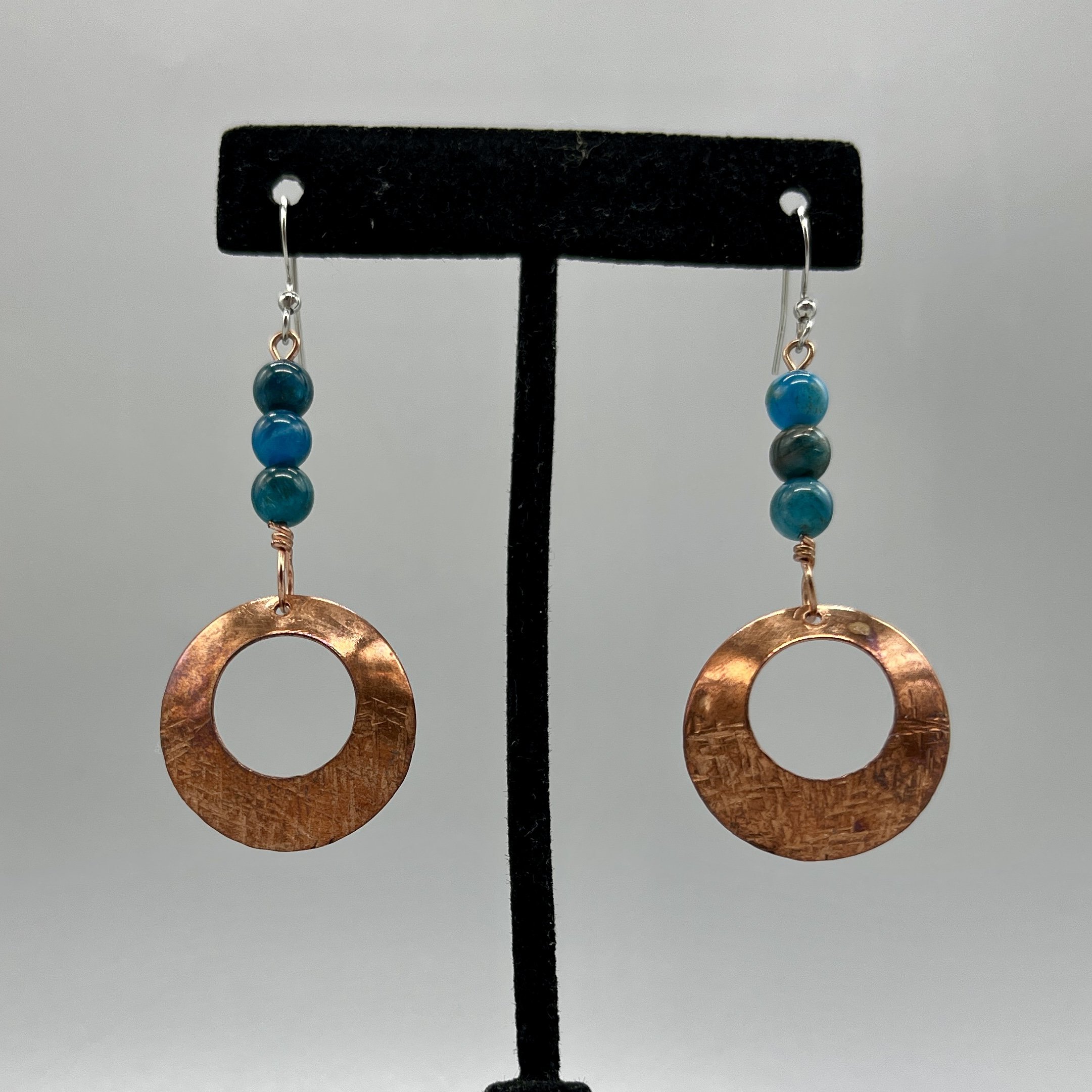 earrings dangle copper O's textured and shaped with blue dyed agate accents
