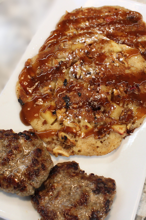 Three nutmeg and cinnamon-spiced buttermilk pancakes with toasted nuts, chopped apple and drizzled with brown sugar syrup OR Two pancakes with a side of Sausage