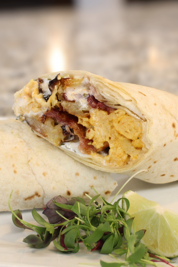 Cheesy chipotle eggs, roasted potatoes, bacon, salsa blanca, root vegetable relish, flour tortilla, add sausage or serve as a hash to make it gluten free