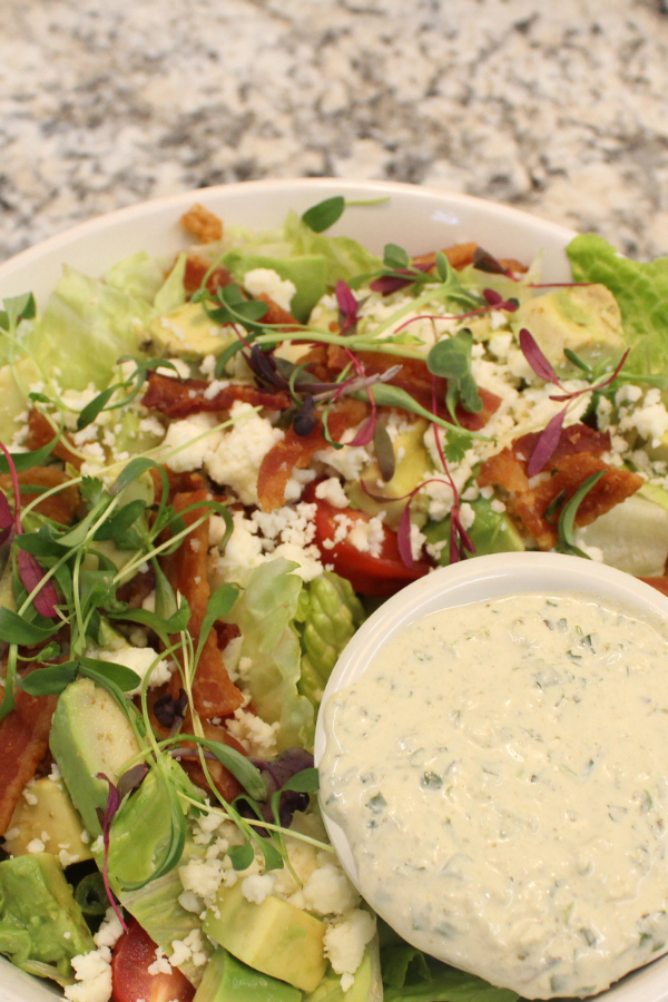 Chopped romaine lettuce, bacon, avocado, cherry tomatoes, and scallions topped with Cotija cheese and a creamy poblano Ranch dressing