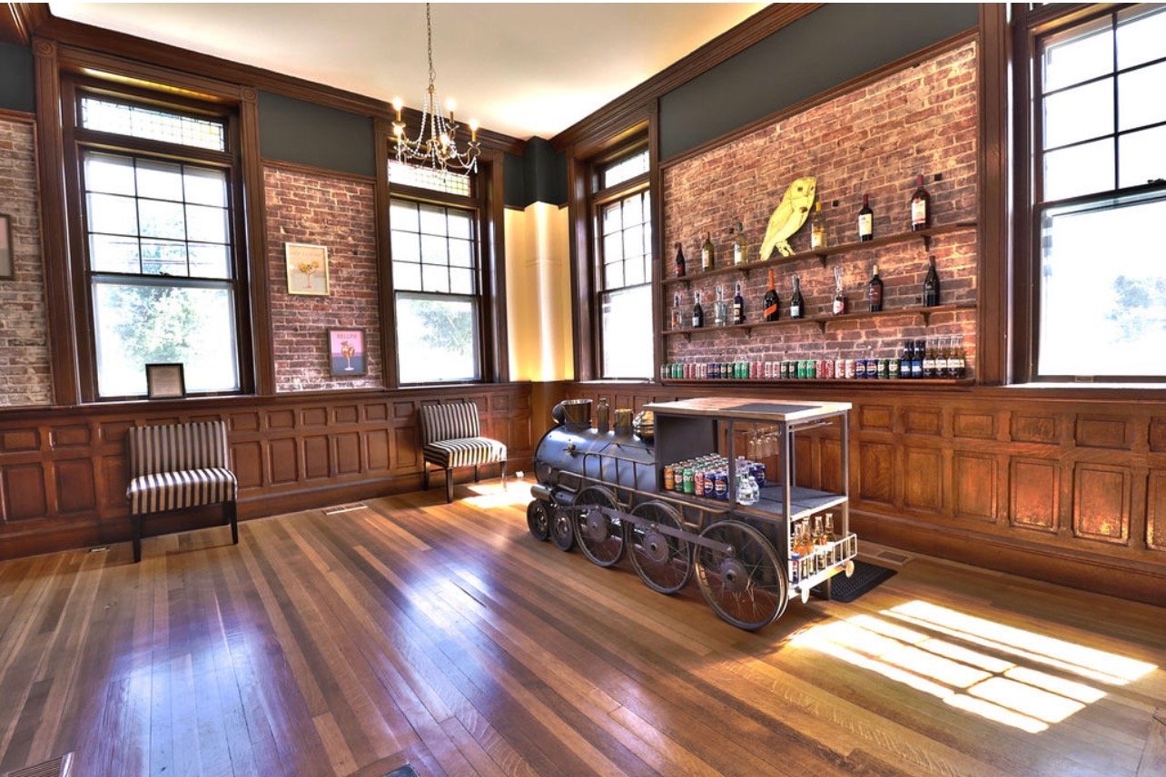 Discover the unique Owl Train Bar at The Grand Chateau Owl Wedding and Event Venue. Featuring elegant design, luxury event spaces, and unforgettable wedding and celebration experiences in a sophisticated chateau-inspired setting.