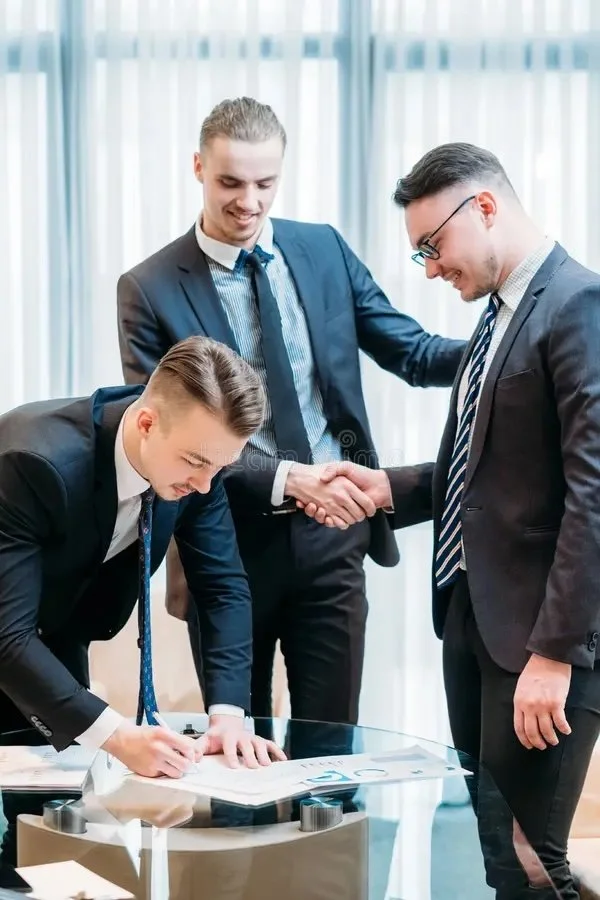 Executives signing and closing a deal.  Handshake between two of them
