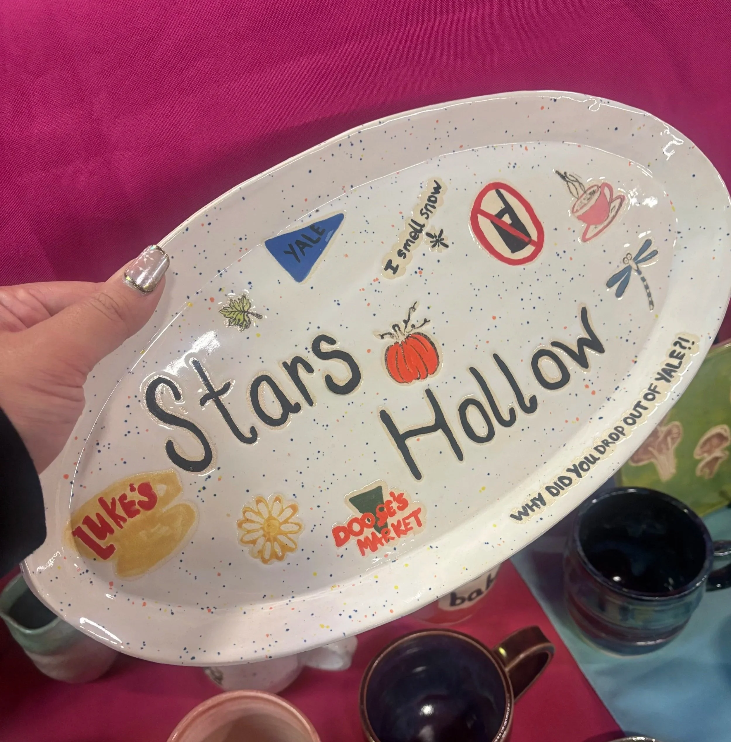 A large oval plate with iconic Gilmore Girls moments written and drawn on.
