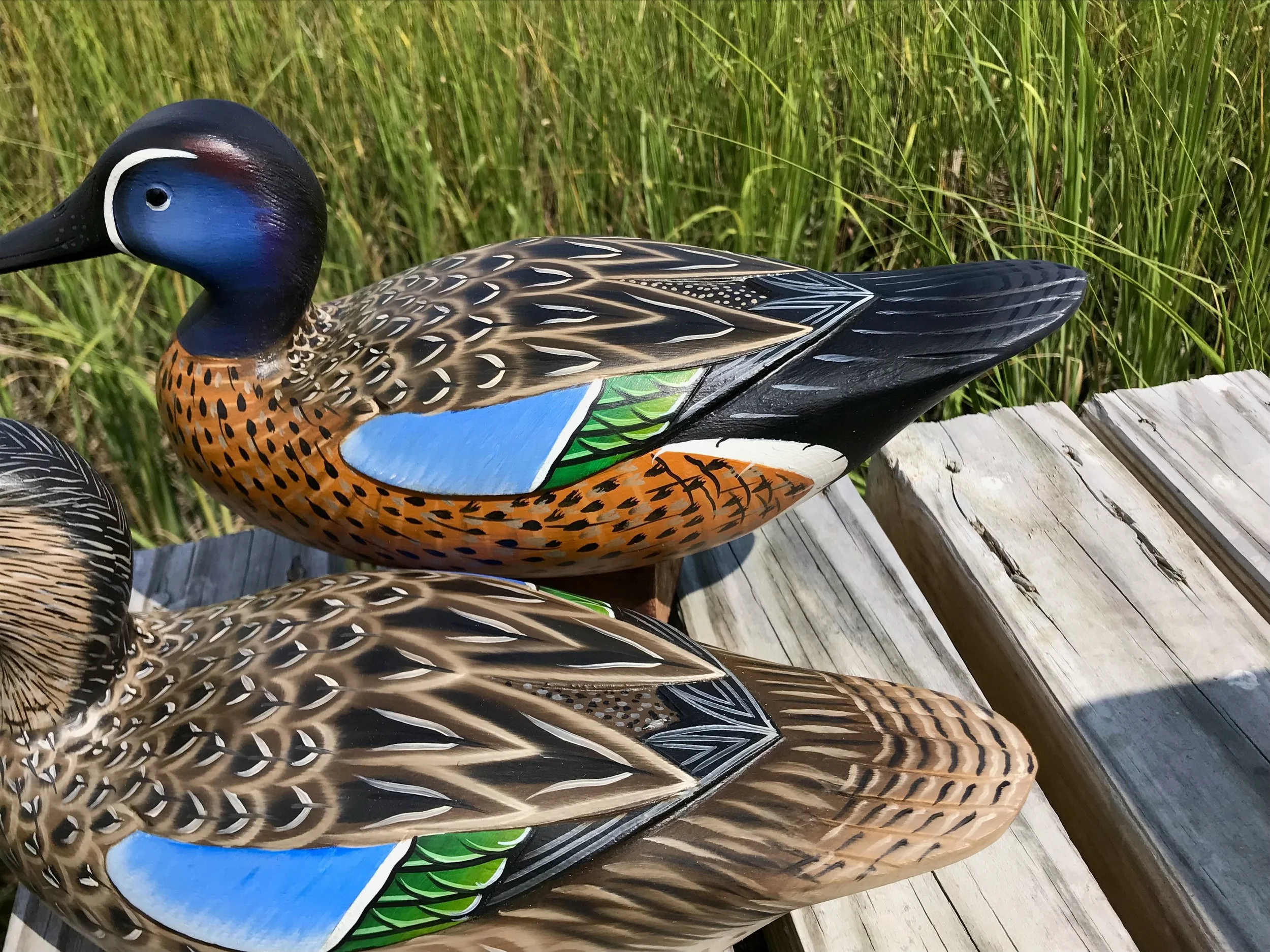 Feather detail on back of the pair.