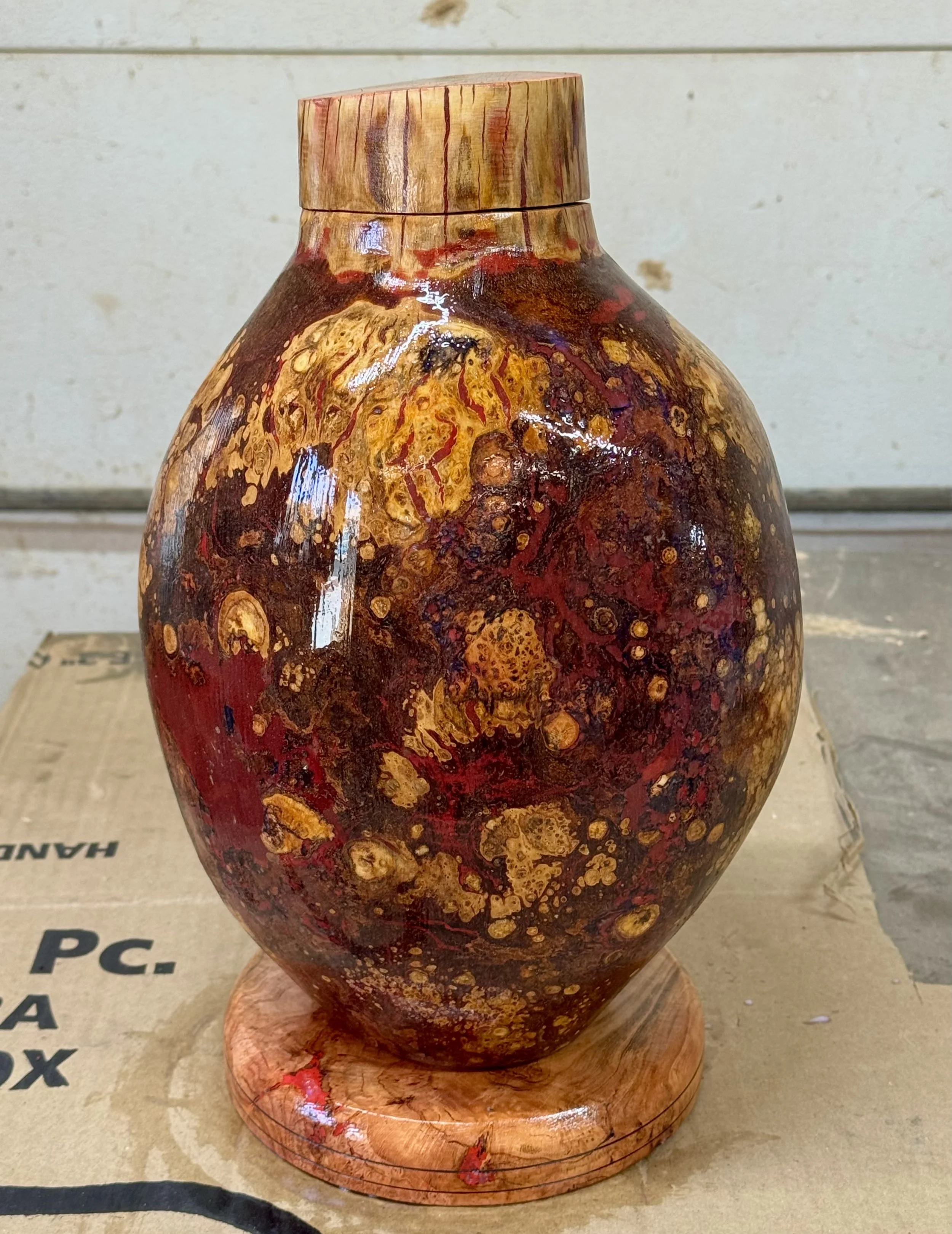 Hand carved Cherry Burl urn with jewel Epoxy inlays. 