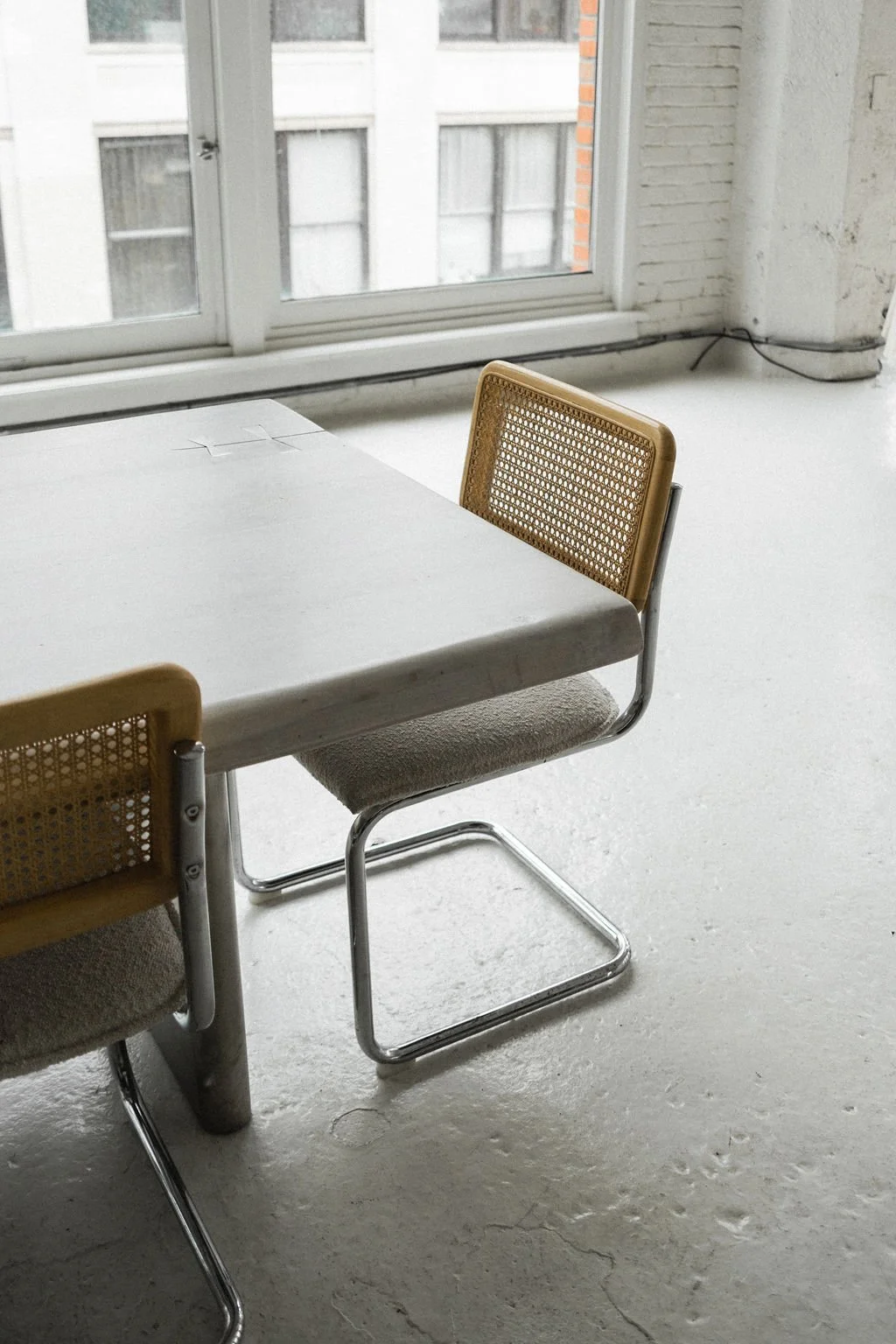 High end kitchen and interior design Fairfield County CT & Charlotte, NC: light-filled studio workspace with table and chairs near large windows.