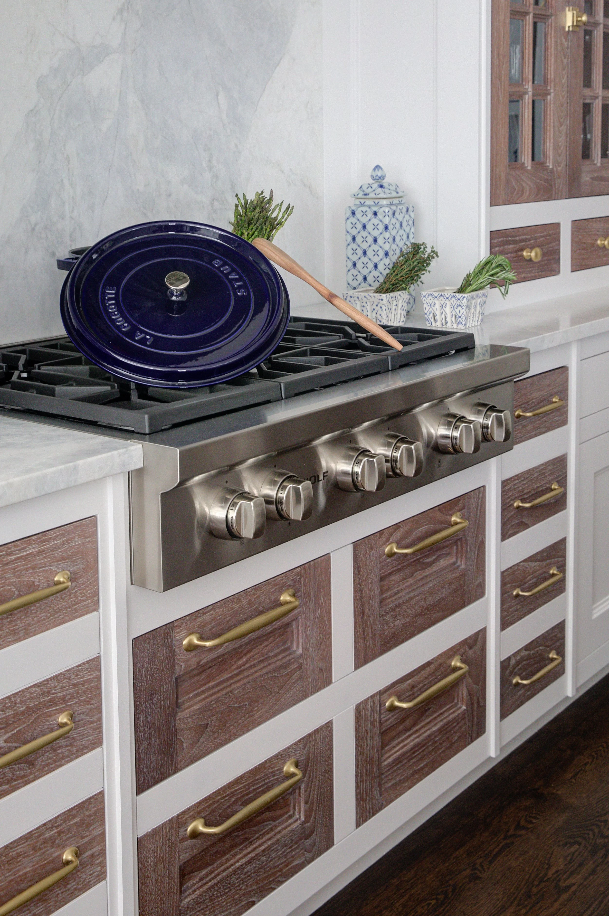 High-end kitchen and interior design in Fairfield County CT & Charlotte, NC: Wolf range with custom wood inset drawers and brass hardware in New Canaan CT.