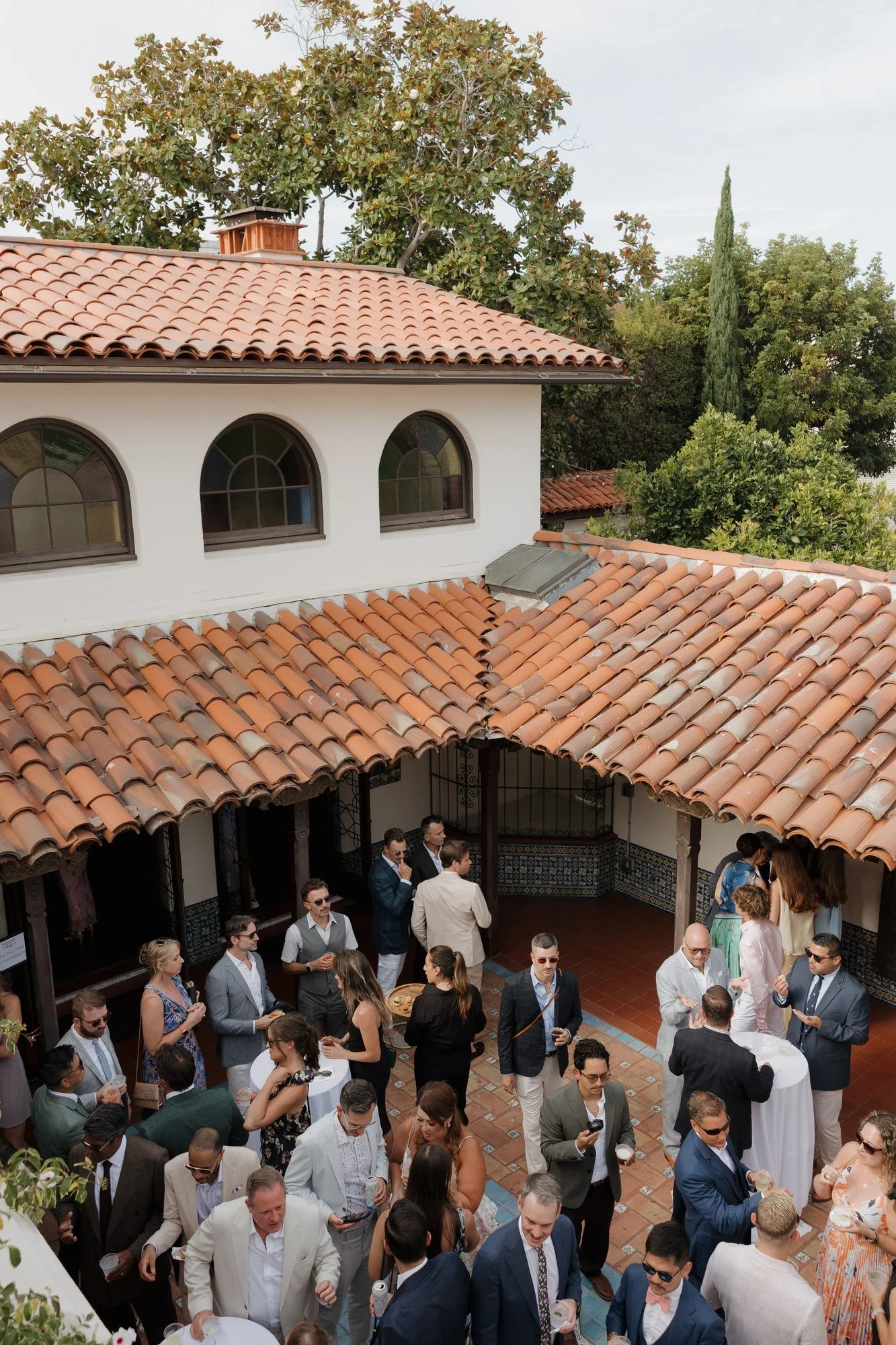 Overhead view of guests at cocktail hour in the Darlington House courtyard