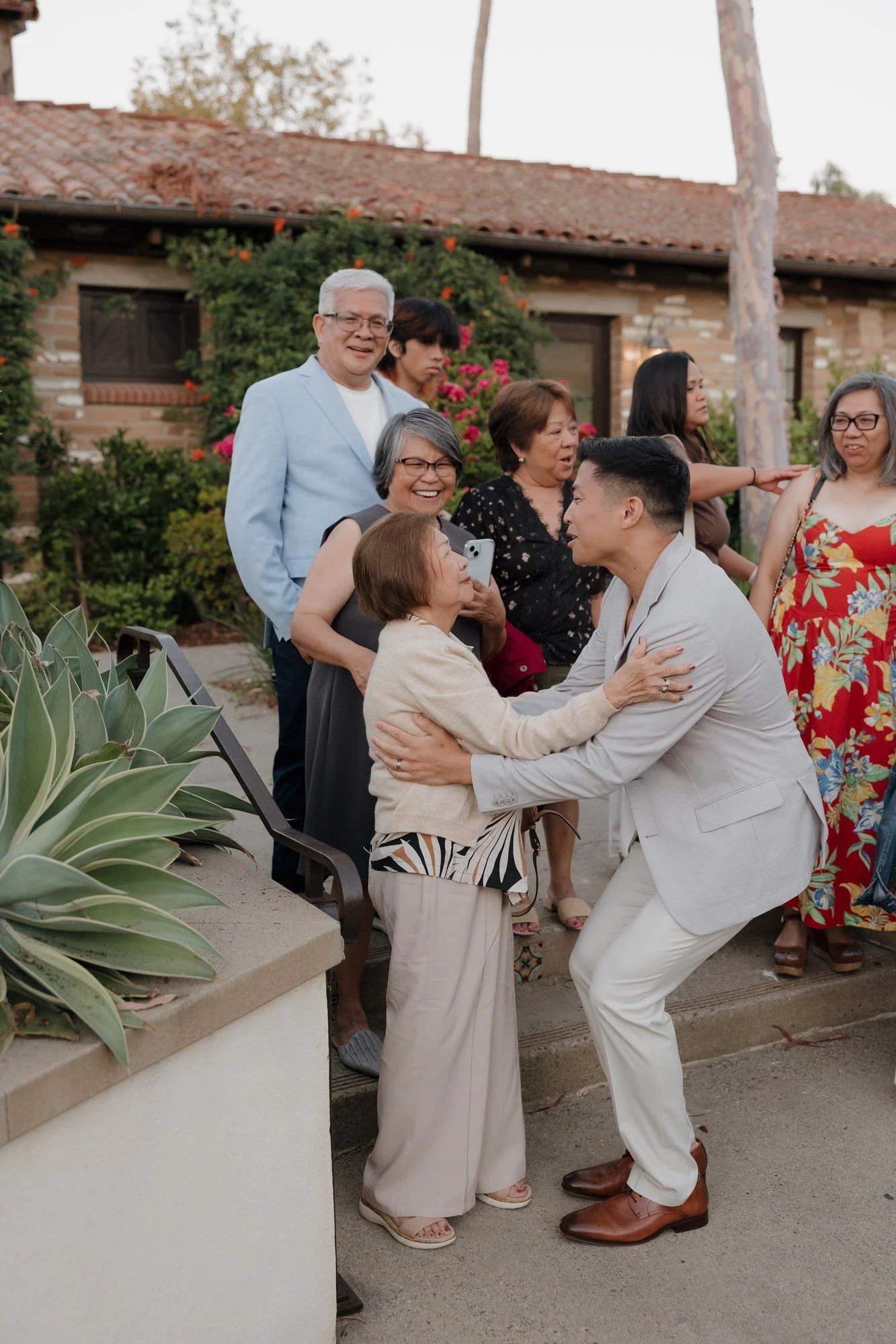 Candid hug between Ryan and a guest at the Estancia La Jolla rehearsal dinner