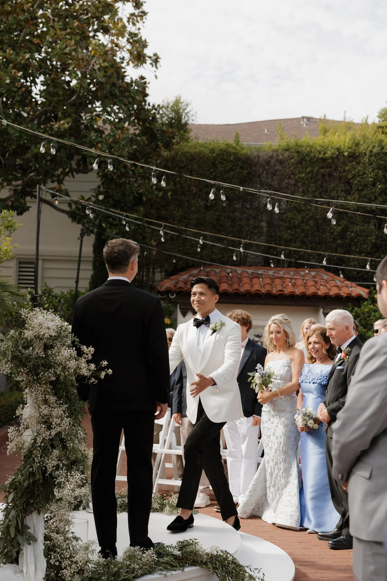 Ryan walking down the aisle with family during the processional at Darlington House
