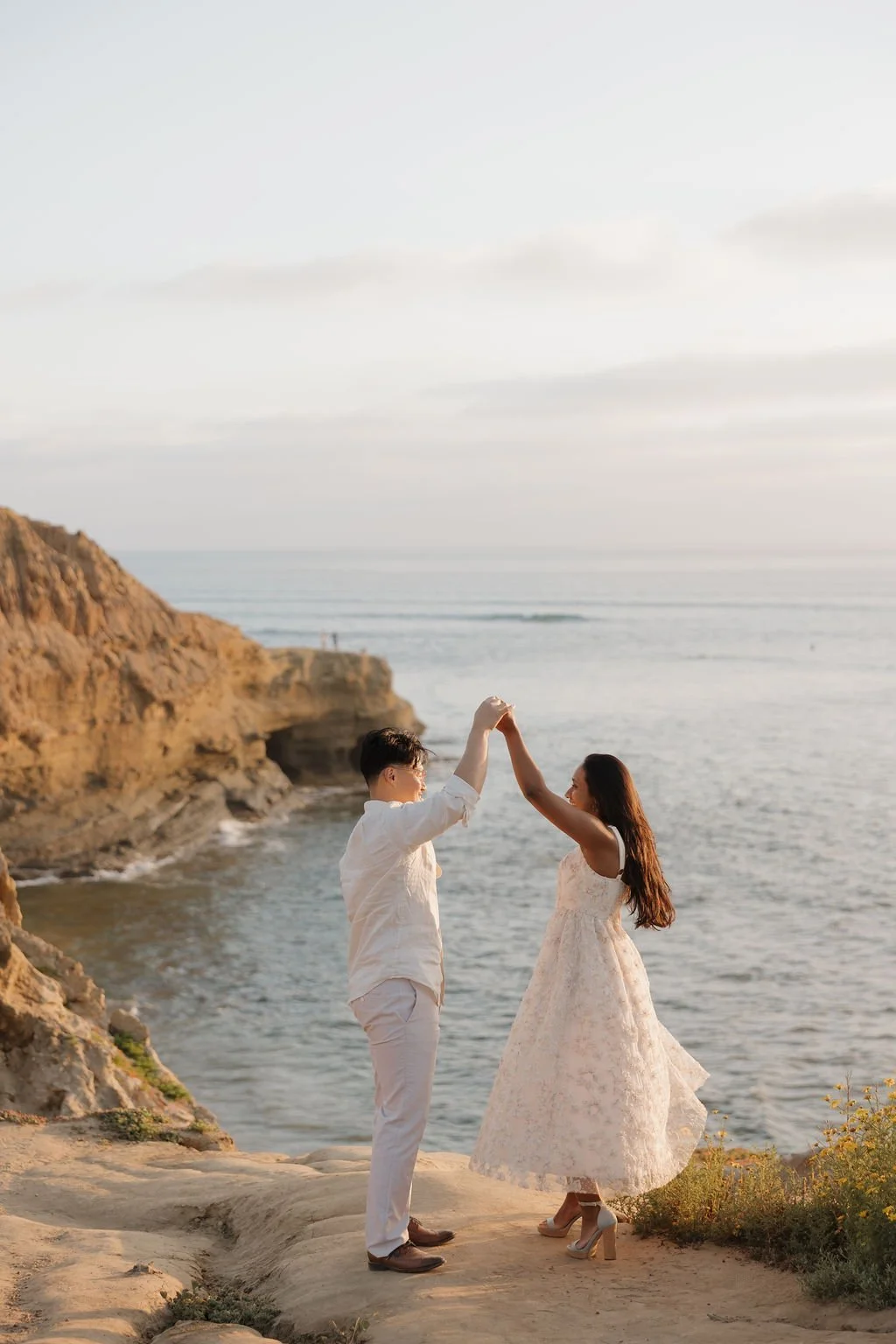 Couple twirling on the cliffs at Sunset Cliffs Natural Park
