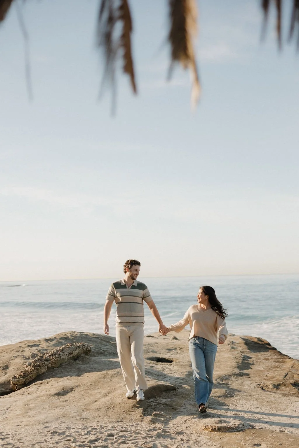 Couple walking along the rocks at Windansea Beach in La Jolla