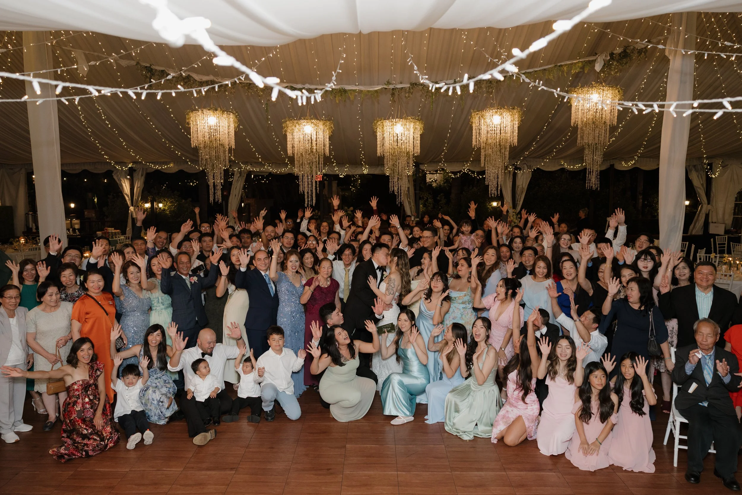 Big group photo of Nancy and Ken with their wedding guests in the Green Gables reception tent