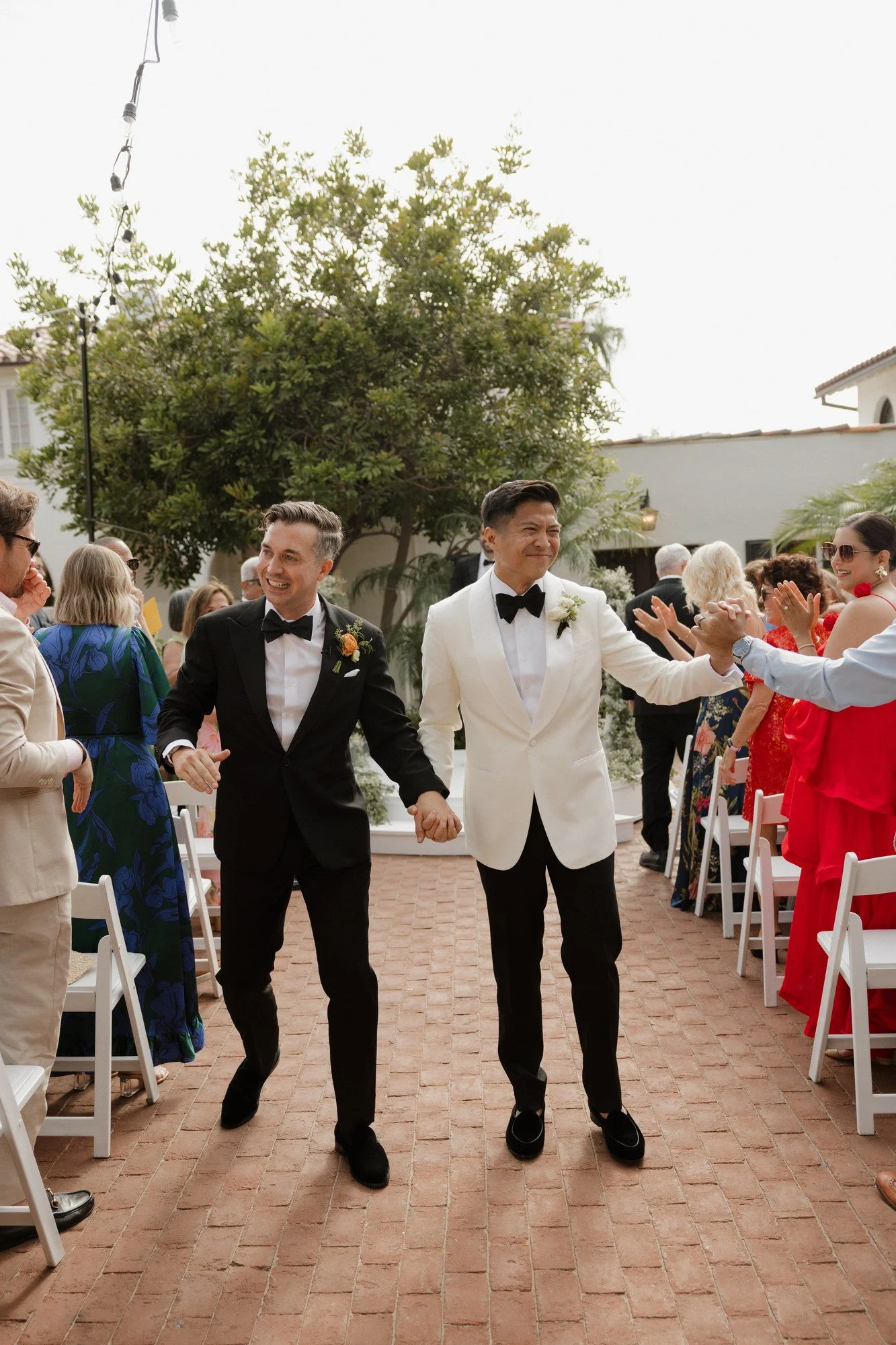 Ryan and Sean walking back up the aisle hand in hand after their Darlington House ceremony