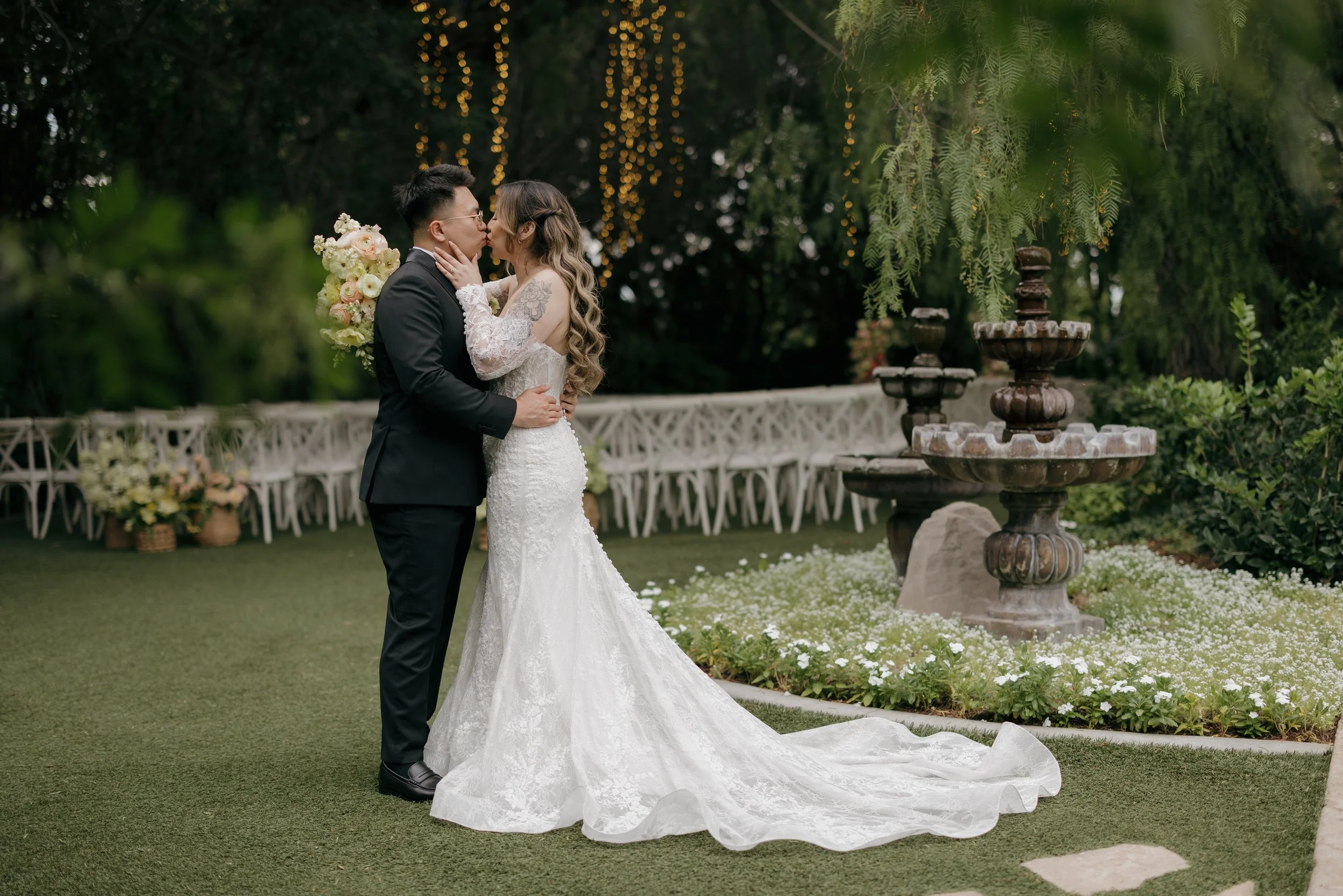 Nancy and Ken kissing beside the garden fountain at Green Gables Wedding Estate